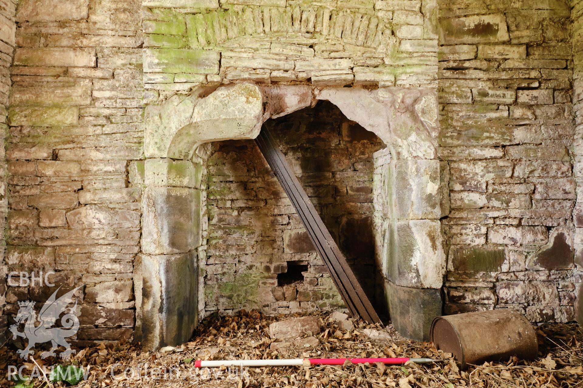 Colour photograph showing Great Porthmel Gatehouse - upper stage fireplace, looking SW. Produced as part of Historic Building Recording for Great Porthamel Gatehouse, carried out by Richard Hayman, April 2021.