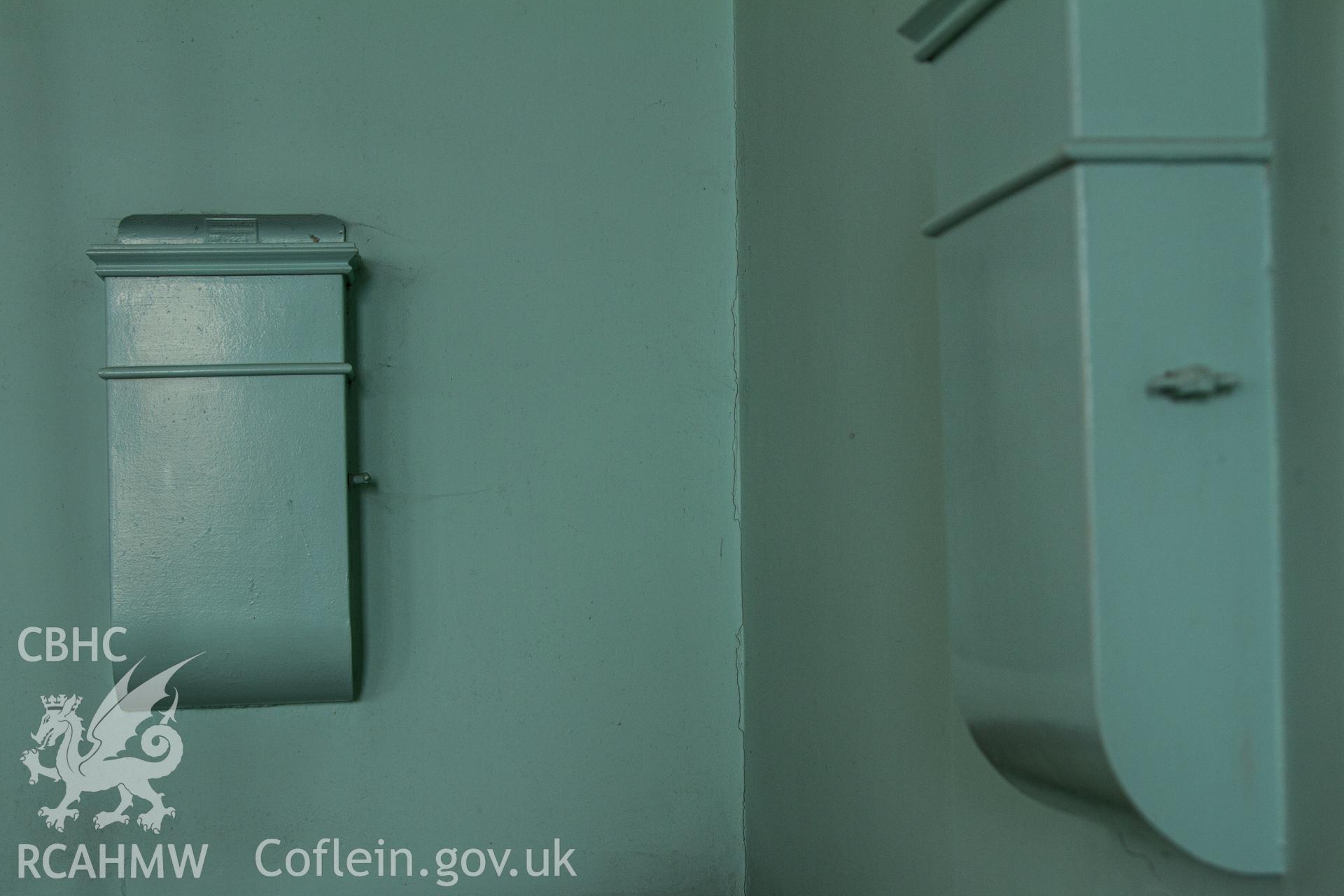 Colour photograph of interior ventilation inlet boxes with mechanical lever handles for ventilation control - part of a photographic survey of Bethania Chapel, Aberangell, Gwynedd, produced for John Linden by Adrian John Hexter as a condition of planning consent. (Planning Application Ref. No. NP5/74/L319). Snowdonia National Park Planning Authority.