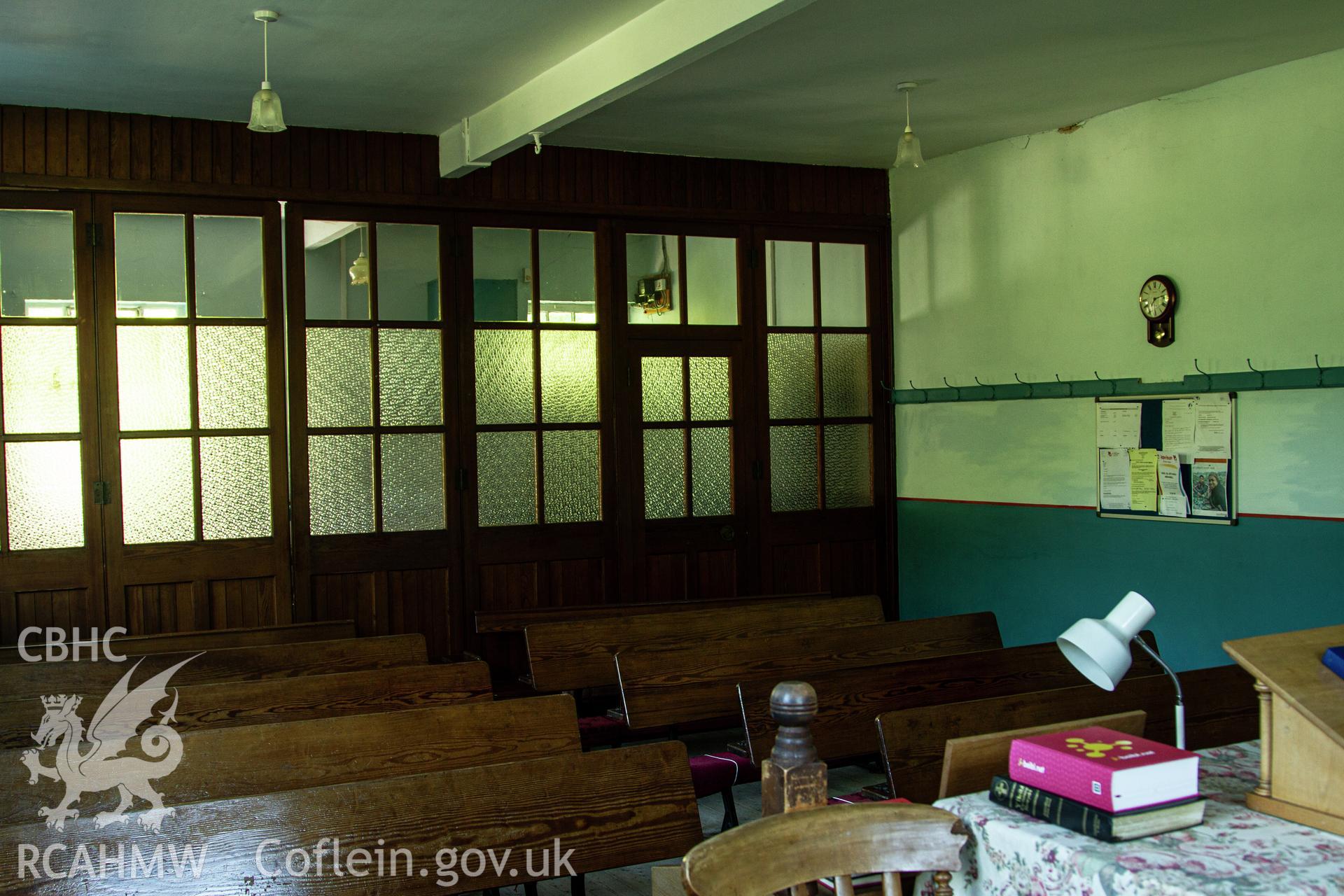 Colour photograph of interior of vestry with glazed fold away partition wall - part of a photographic survey of Bethania Chapel, Aberangell, Gwynedd, produced for John Linden by Adrian John Hexter, as a condition of planning consent. (Planning Application Ref. No. NP5/74/L319). Snowdonia National Park Planning Authority.