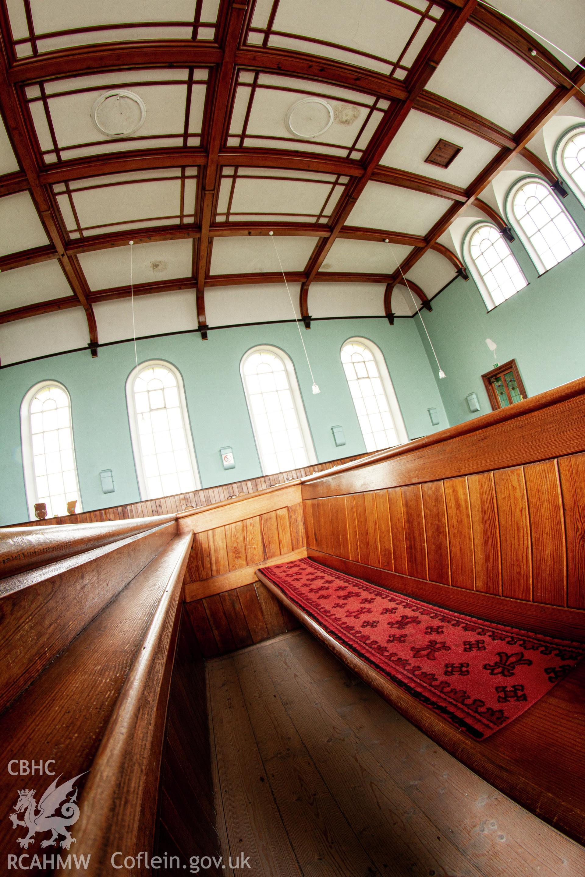 Colour photograph of interior - pew detail - part of a photographic survey of Bethania Chapel, Aberangell, Gwynedd, produced for John Linden by Adrian John Hexter, as a condition of planning consent. (Planning Application Ref. No. NP5/74/L319). Snowdonia National Park Planning Authority.