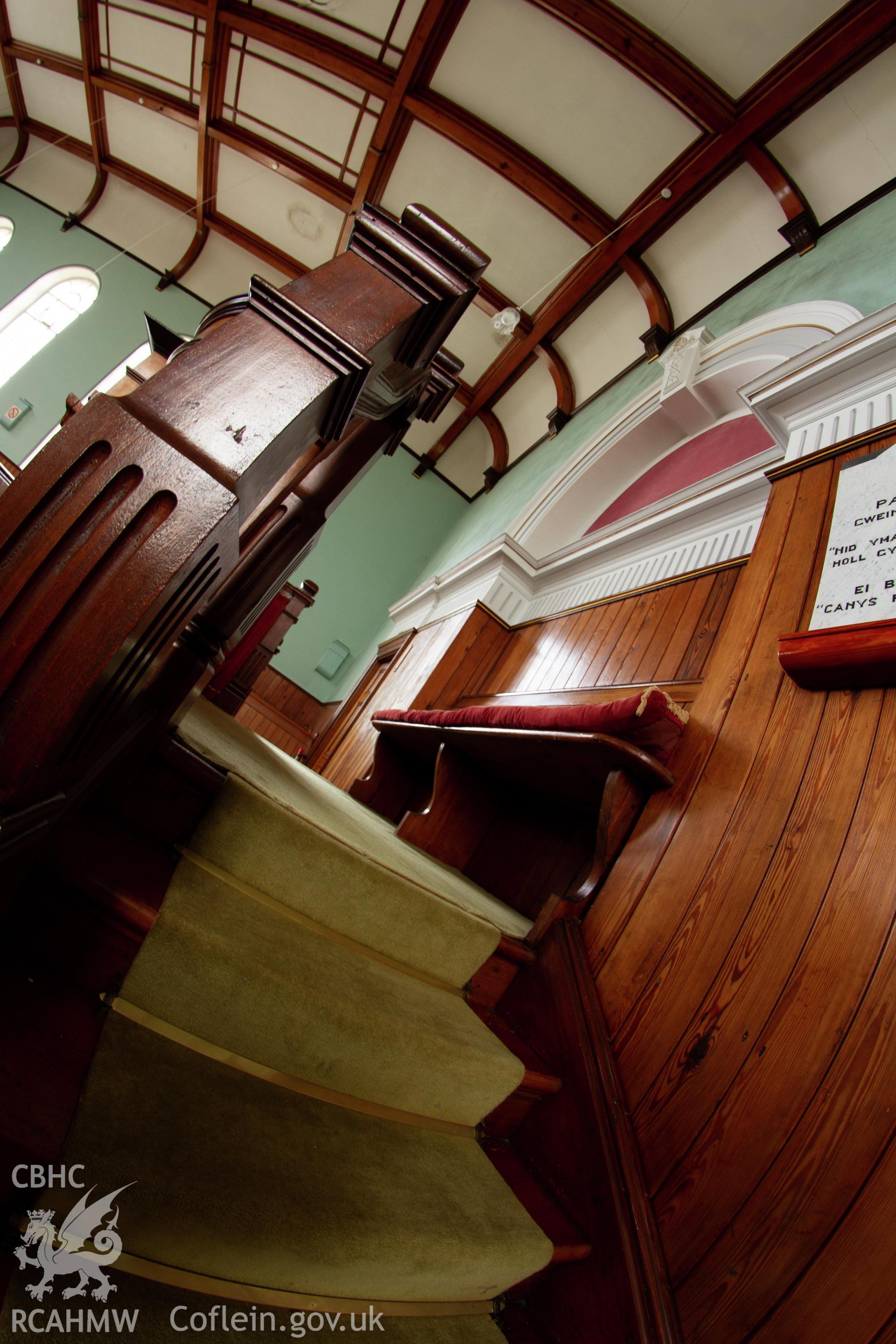 Colour photograph of interior - steps leading up to pulpit - part of a photographic survey of Bethania Chapel, Aberangell, Gwynedd, produced for John Linden by Adrian John Hexter, as a condition of planning consent. (Planning Application Ref. No. NP5/74/L319). Snowdonia National Park Planning Authority.
