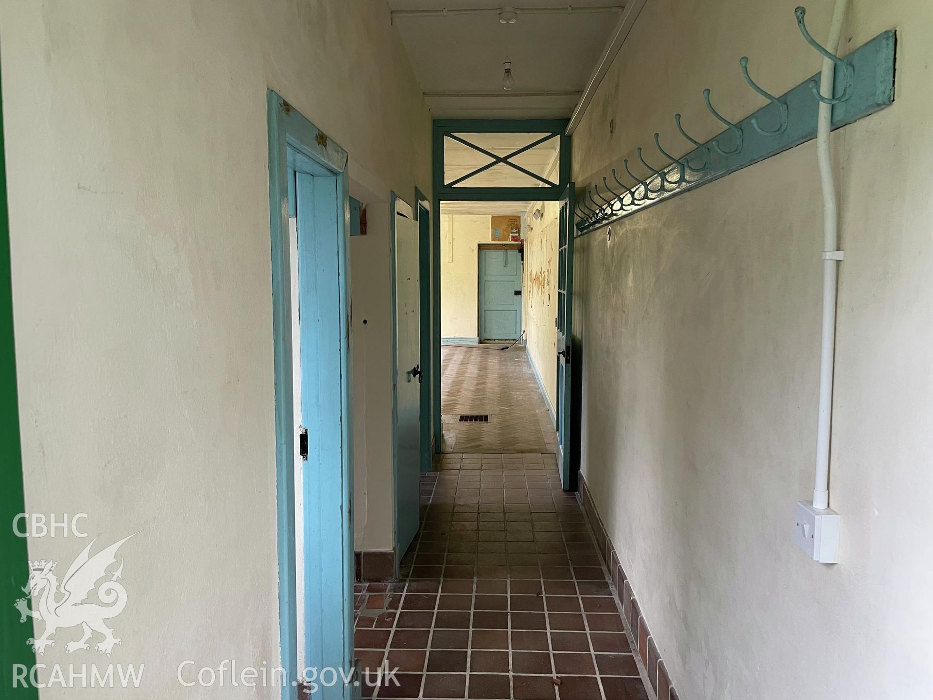 Colour photograph showing Schoolroom corridor, facing north - part of a photographic record relating to Moriah Chapel, Llanystumdwy, produced as a condition of planning consent (Planning Reference C21/0420/41/LL; Gwynedd Council).