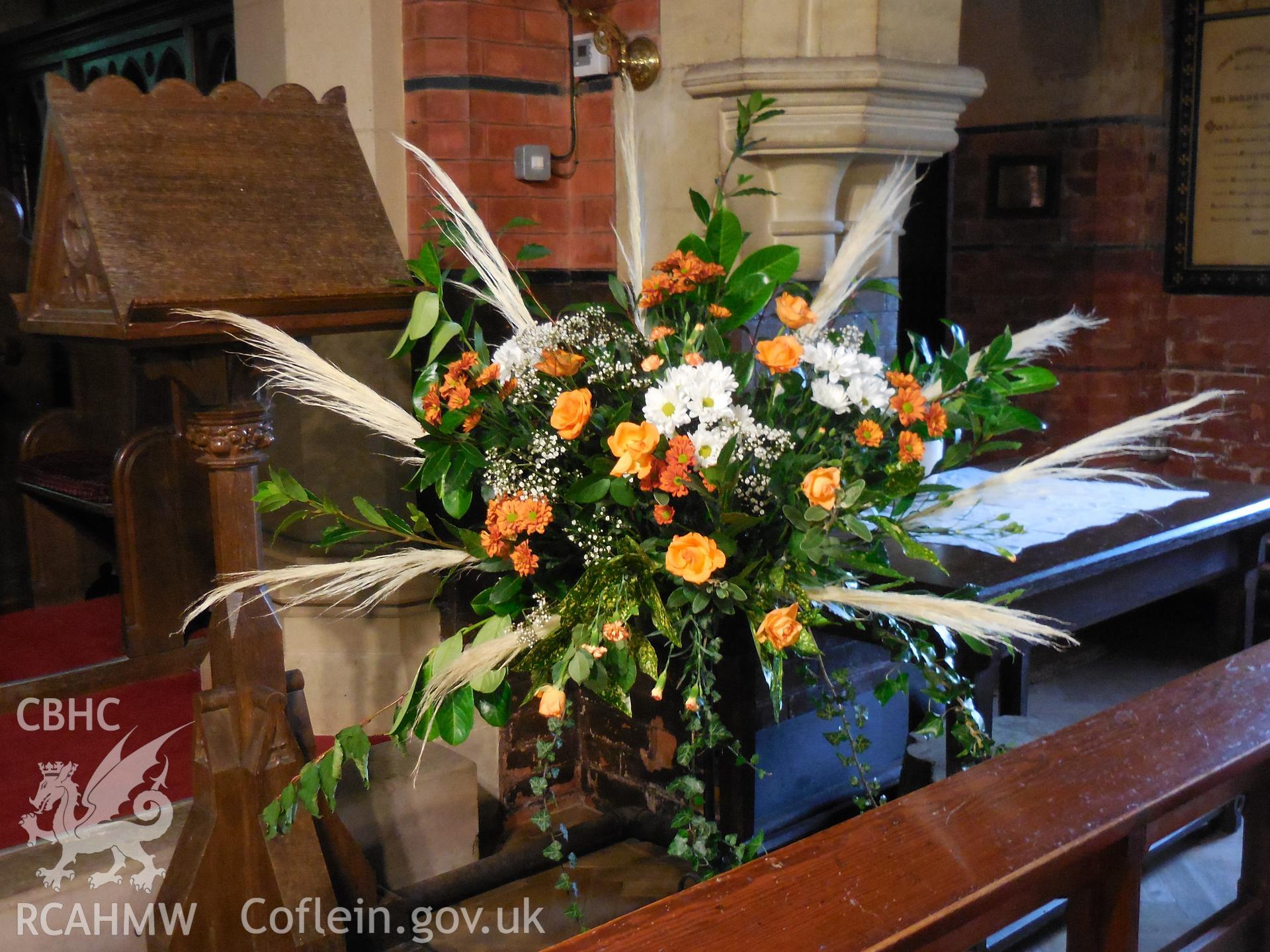 Colour digital photograph showing  interior of St Wyddyn's church - flower decoration during harvest festival 2021.