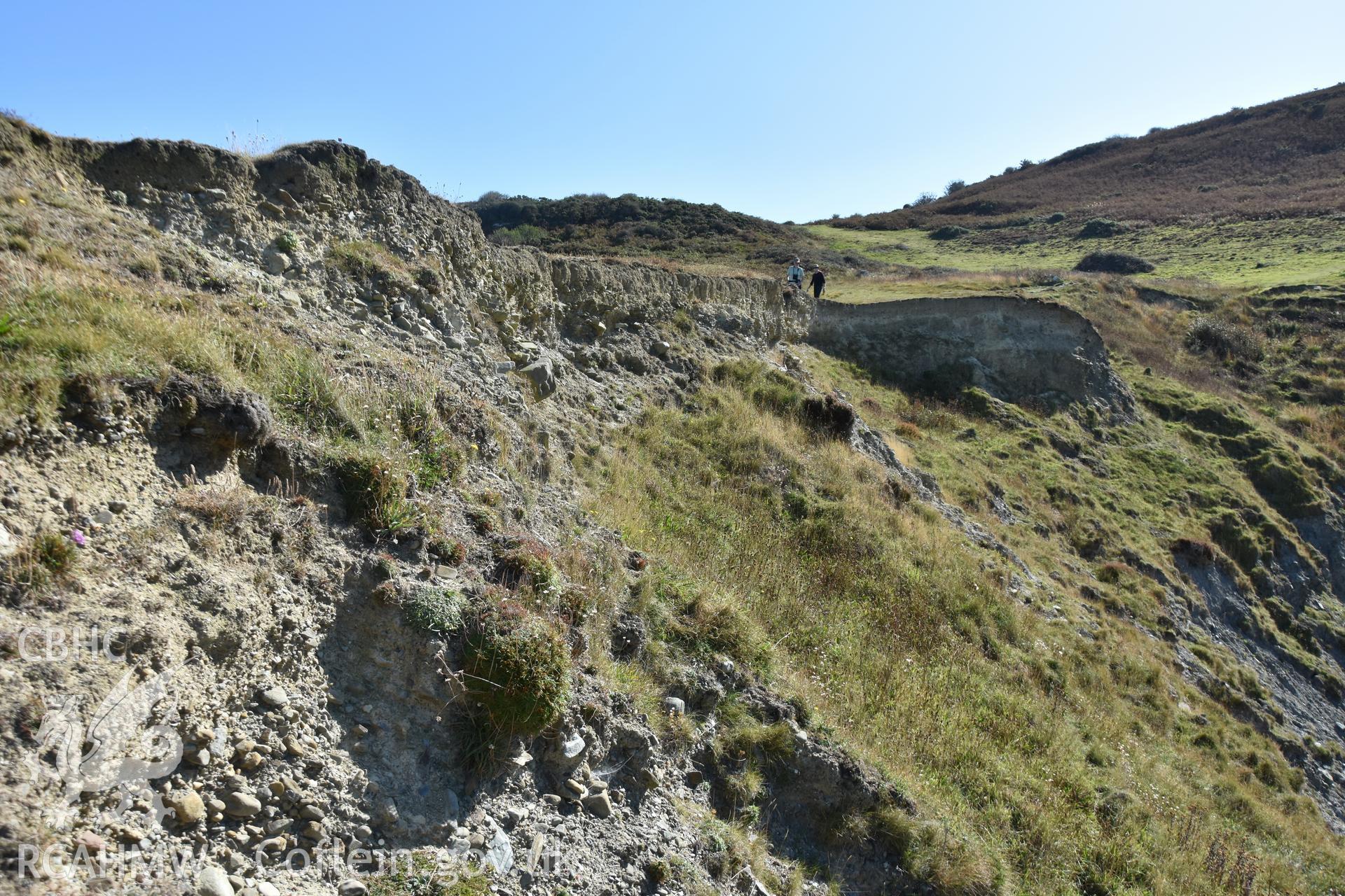 Eroding section. Camera facing S. Survey team in shot. From photographic survey of Castell Bach (NPRN 93914) by Dr Toby Driver for site monitoring 19/09/2019.
Produced with EU funds through the Ireland Wales Co-operation Programme 2014-2020. All material made freely available through the Open Government Licence.