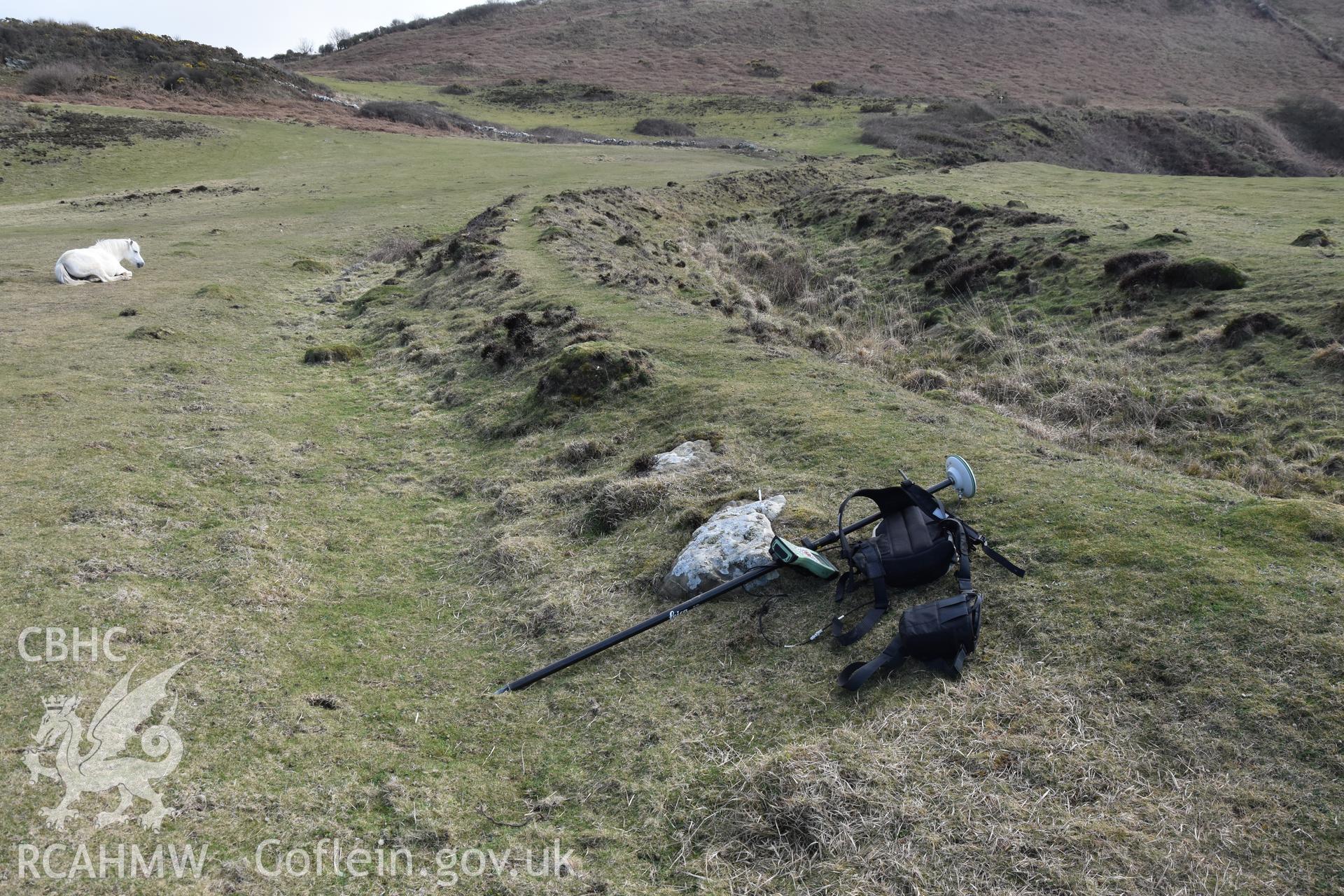 Inner ramparts and ditch with GNSS survey equipment and a horse. Camera facing S. From photographic survey of Castell Bach (NPRN 93914) by Dr Toby Driver for site monitoring 27/03/2019.
Produced with EU funds through the Ireland Wales Co-operation Programme 2014-2020. All material made freely available through the Open Government Licence.