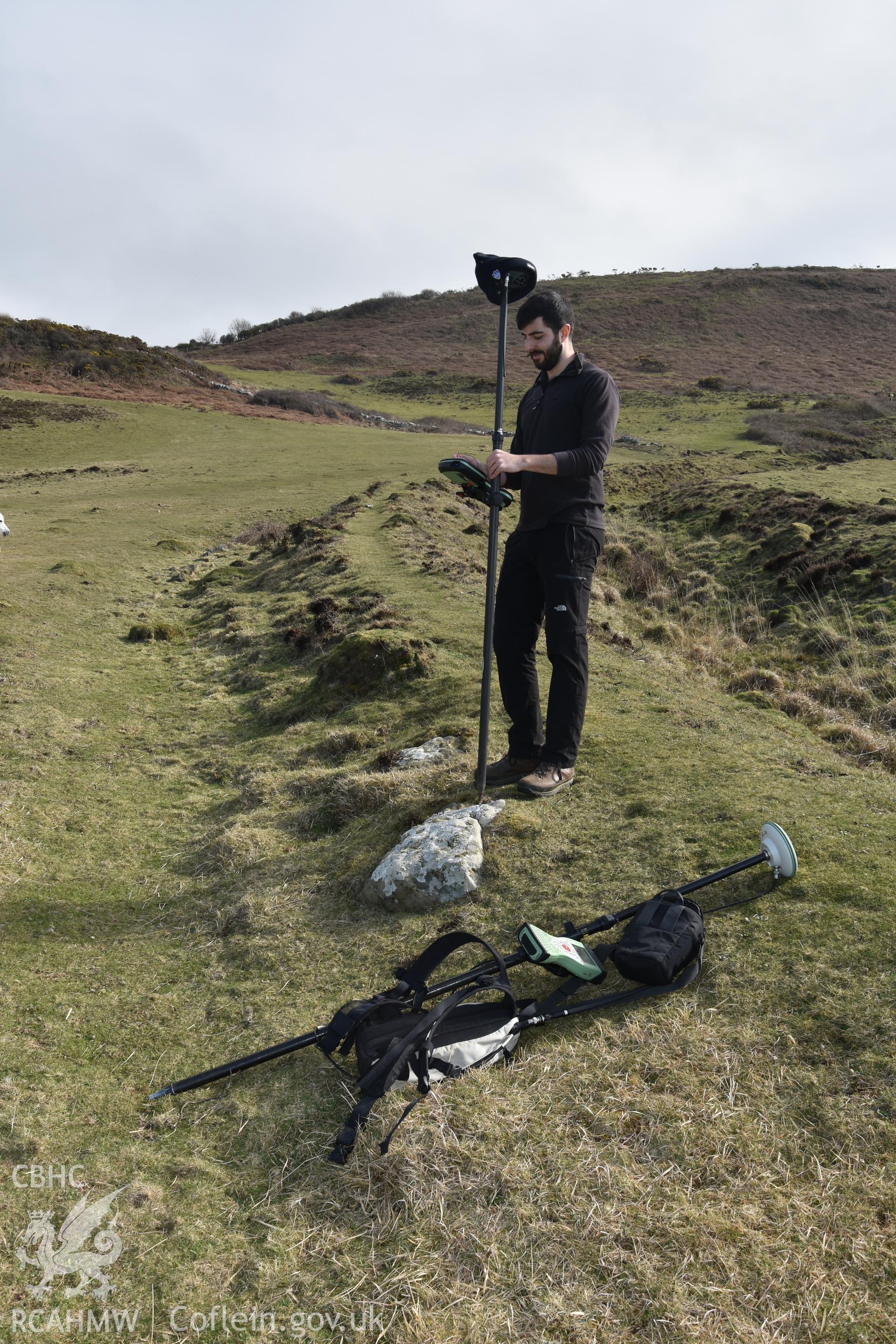 Inner ramparts and ditch with GNSS survey equipment and survey staff. Camera facing S. From photographic survey of Castell Bach (NPRN 93914) by Dr Toby Driver for site monitoring 27/03/2019.
Produced with EU funds through the Ireland Wales Co-operation Programme 2014-2020. All material made freely available through the Open Government Licence.