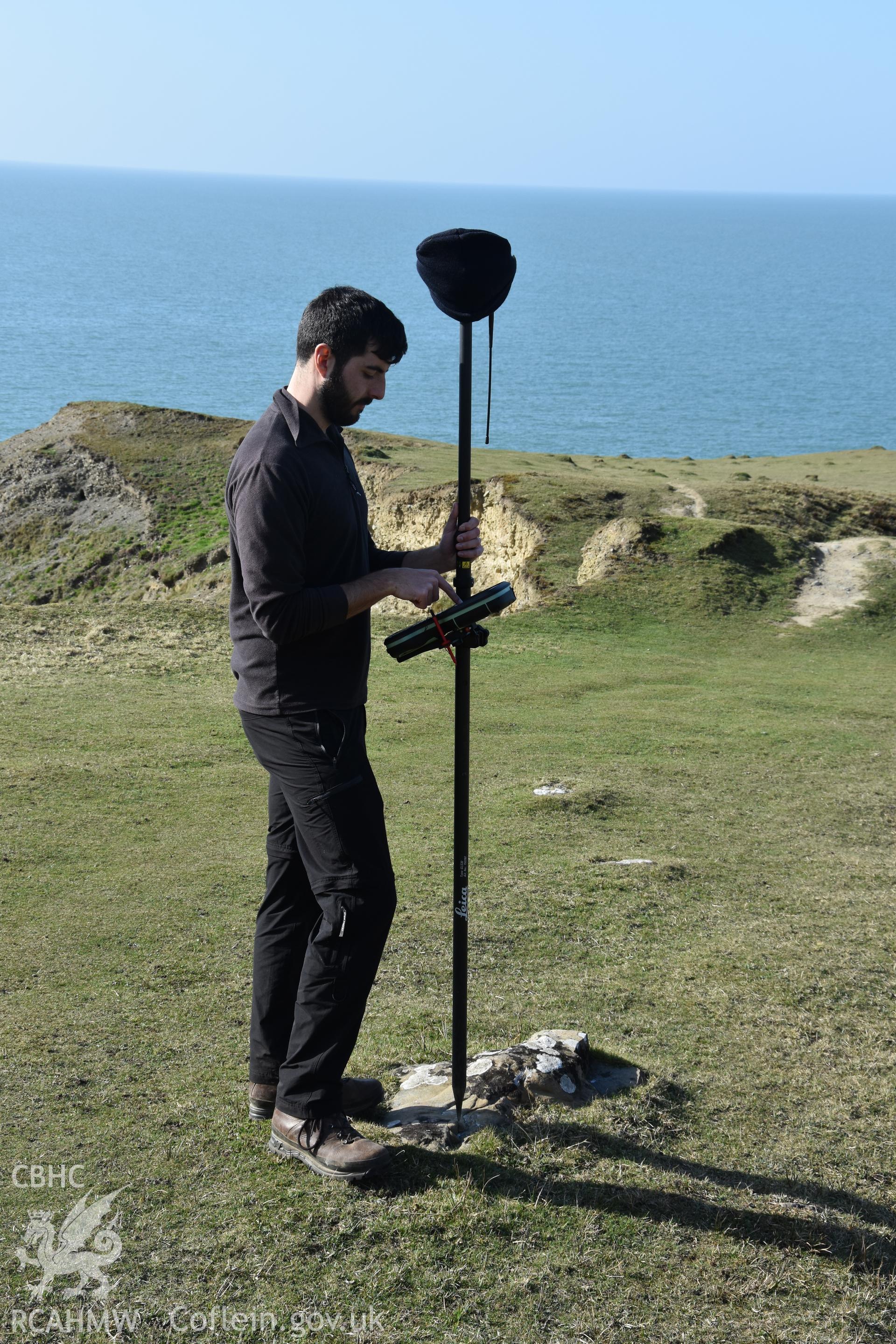 CHERISH project team measuring location of survey marker. Camera facing N. From photographic survey of Castell Bach (NPRN 93914) by Dr Toby Driver for site monitoring 27/03/2019.
Produced with EU funds through the Ireland Wales Co-operation Programme 2014-2020. All material made freely available through the Open Government Licence.