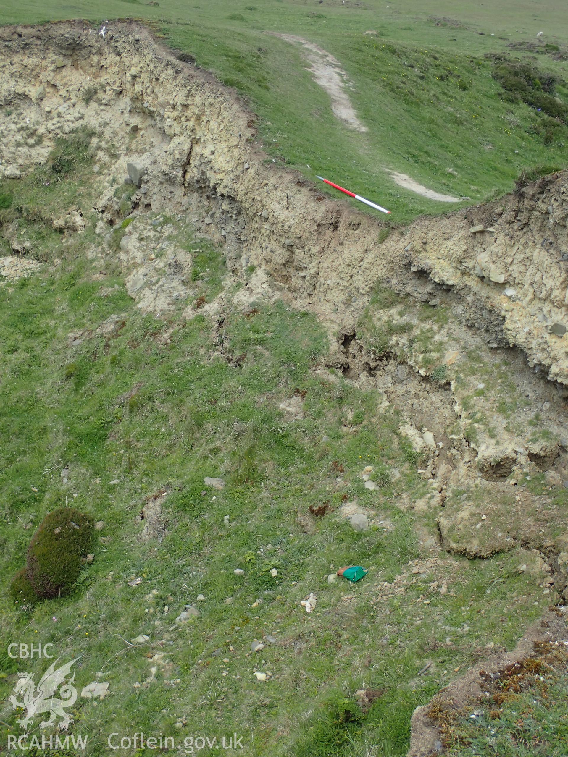 Eroding section photographed from above, showing ramparts and ditch, with scale and people. From photographic survey of Castell Bach promontory fort (NPRN 93914) by Daniel Hunt for CHERISH project condition monitoring 27/05/2021.
Produced with EU funds through the Ireland Wales Co-operation Programme 2014-2020. All material made freely available through the Open Government Licence.