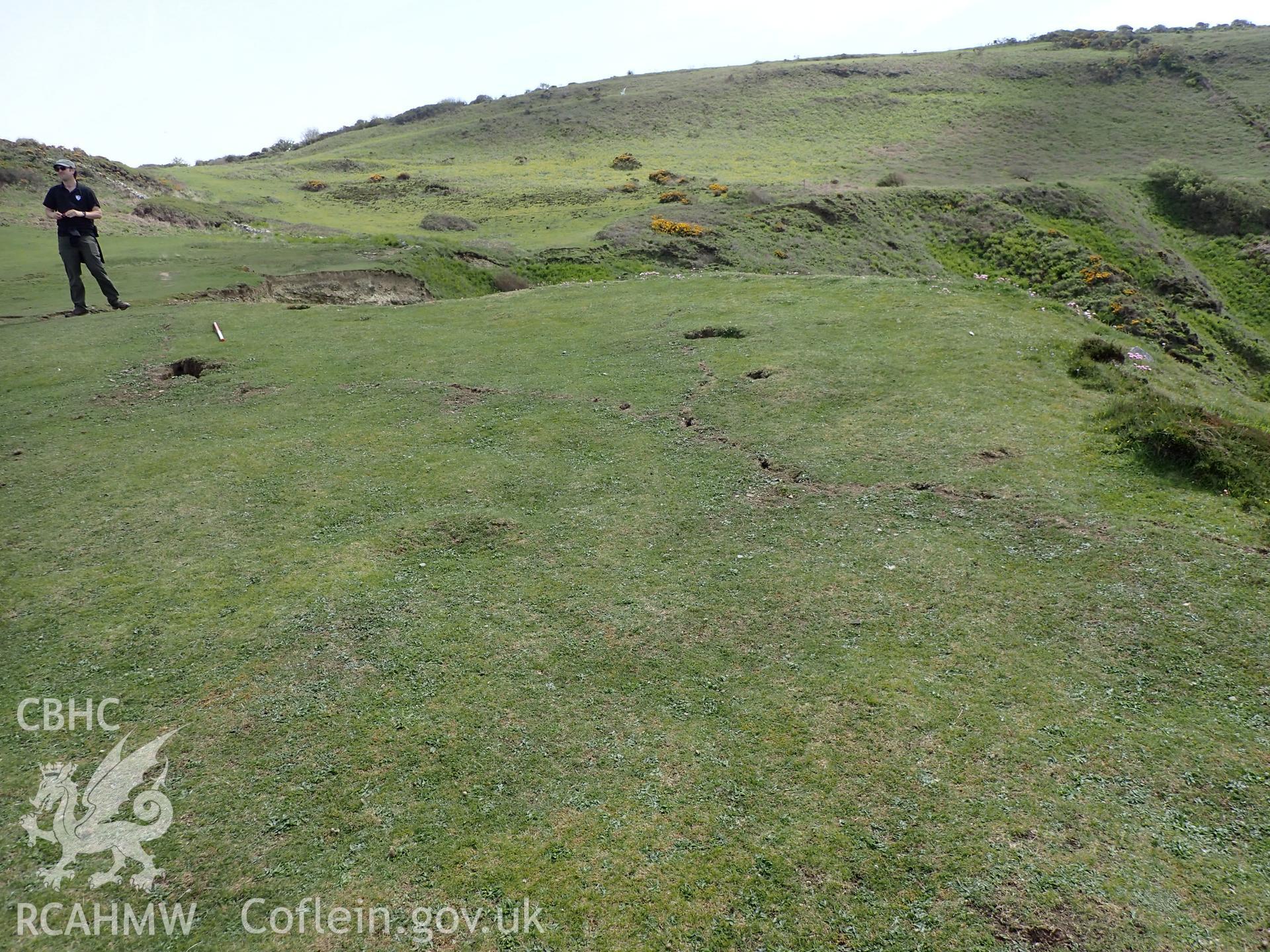 Crack or animal activity with 1m scale and figure. From photographic survey of Castell Bach promontory fort (NPRN 93914) by Daniel Hunt for CHERISH project condition monitoring 27/05/2021.
Produced with EU funds through the Ireland Wales Co-operation Programme 2014-2020. All material made freely available through the Open Government Licence.