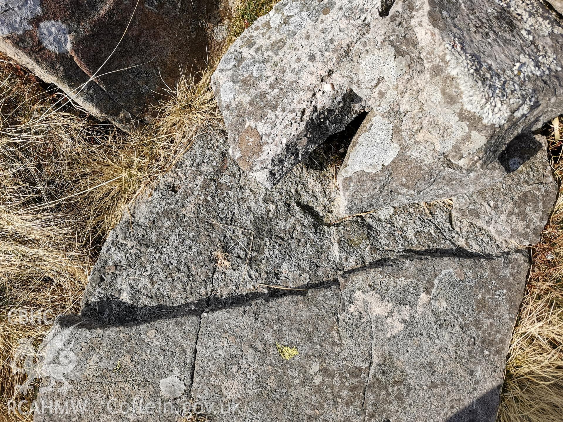 Photograph showing broken standing stone north of Nant y Coetgae cottage, taken March 2022.