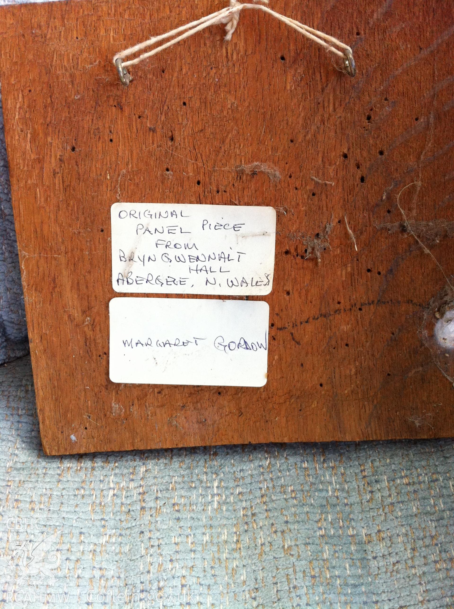 Digital photograph of wooden panel labelled 'original panel piece from Bryngwenallt Hall, Abergele, North Wales. Margaret Gordon.' Photographed in 2017 by Gillian Swan.