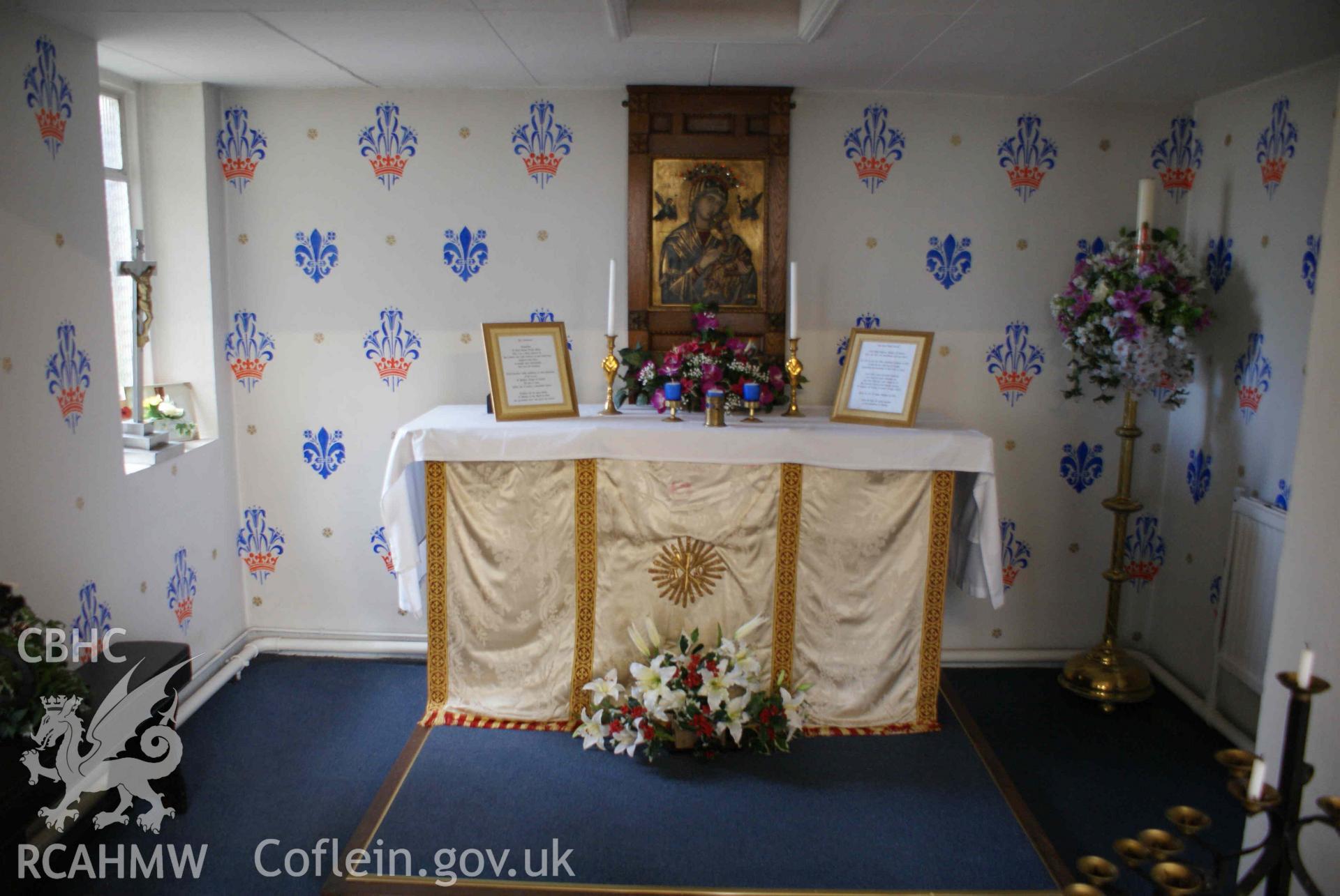 Digital colour photograph showing the Lady Chapel with an icon of Our Lady of Perpetual Succour set within an oak Arts and Crafts style frame at St Mary's Catholic church, Abertillery.