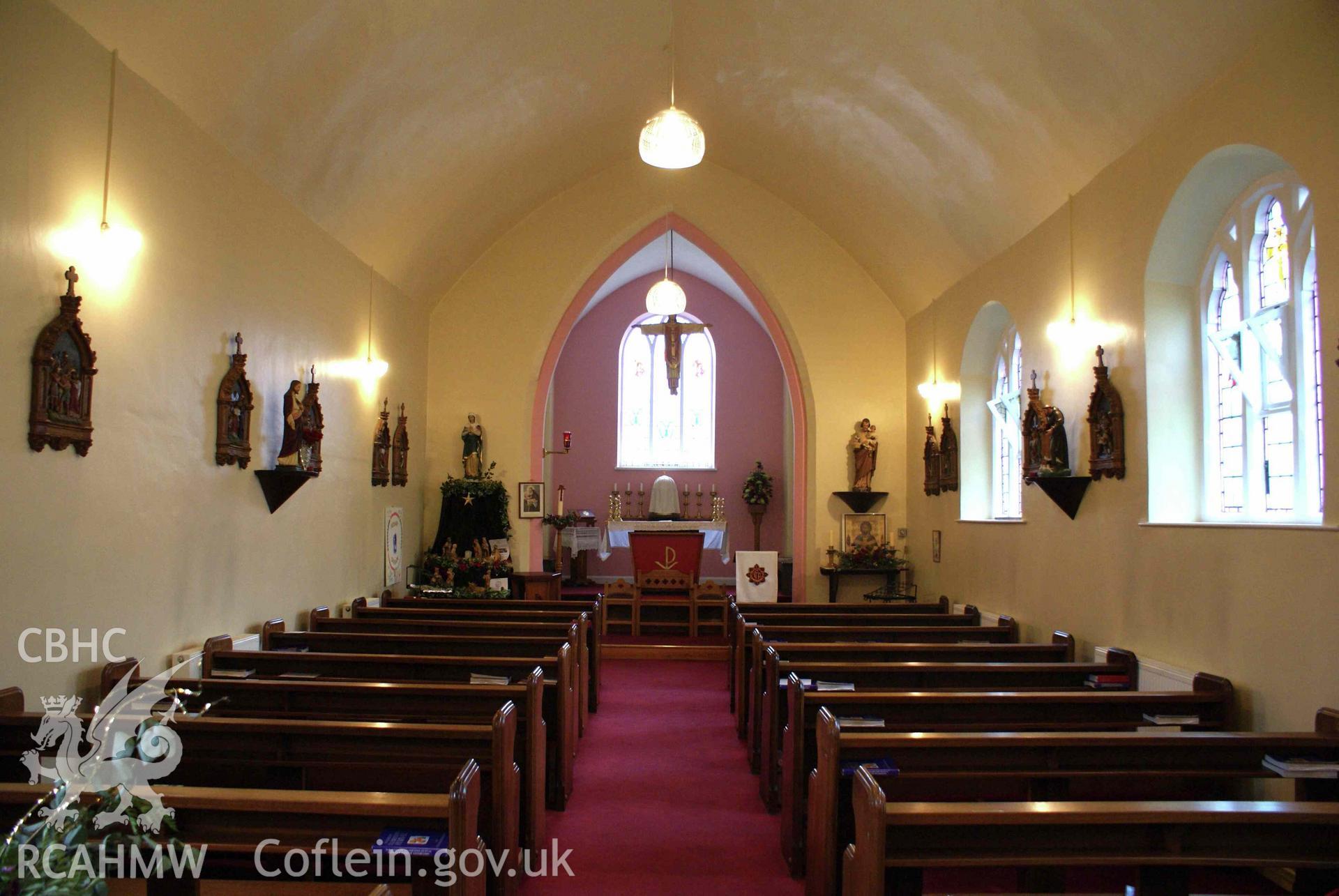 Digital colour photograph showing the interior with the Stations of the Cross on either side at Sacred Heart and St Felix Catholic church, Blaenavon.