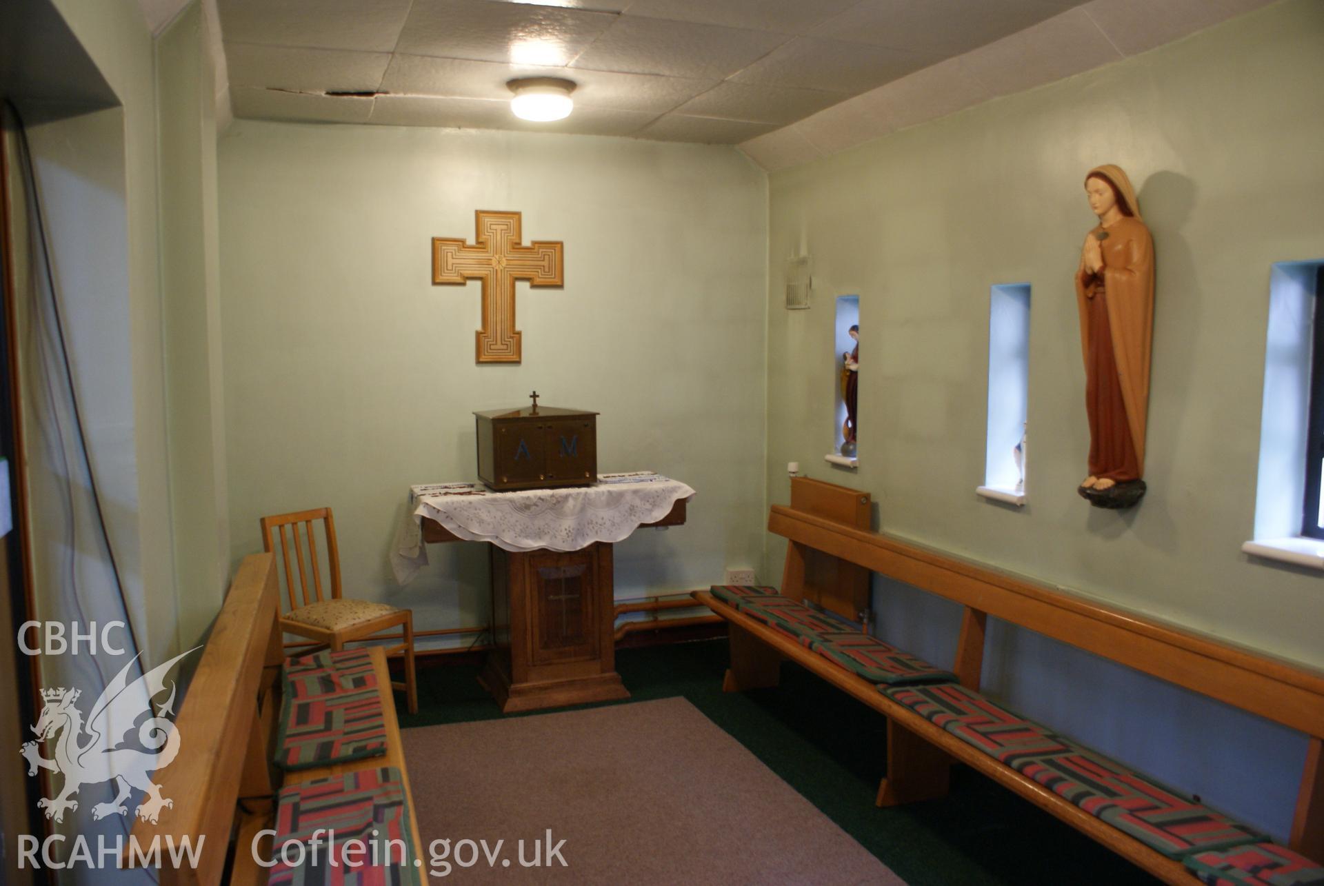 Digital colour photograph showing painted wooden statue of St Dyfrig in the former baptistry at St Dyfrig's Catholic church, Treforest.