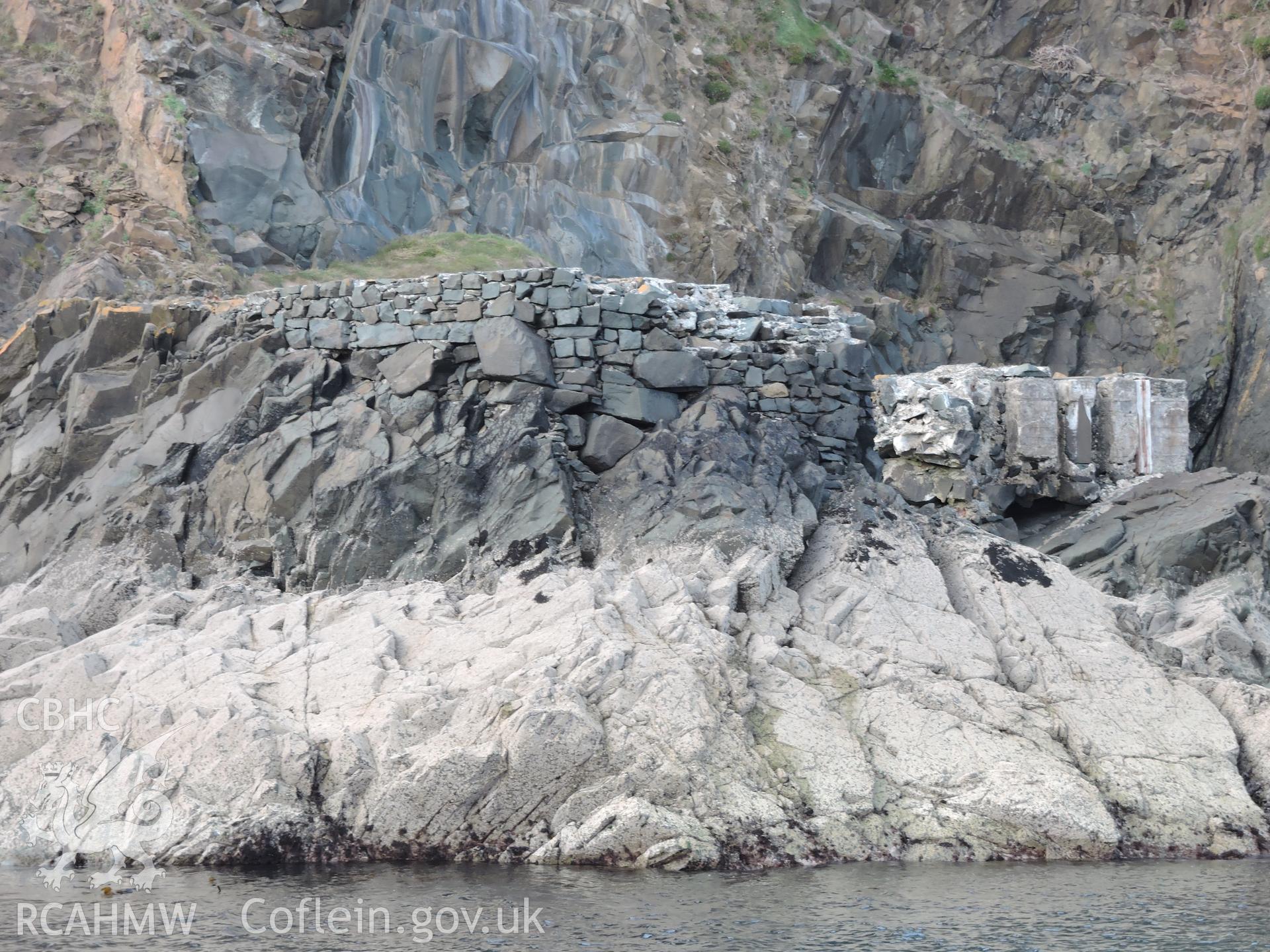 Detailed view showing the remains of the stone walls of the quay, viewed from the sea. Part of a digital photographic survey of Porth y Pistyll, Aberdaron, produced in 2020 by Michael Statham.