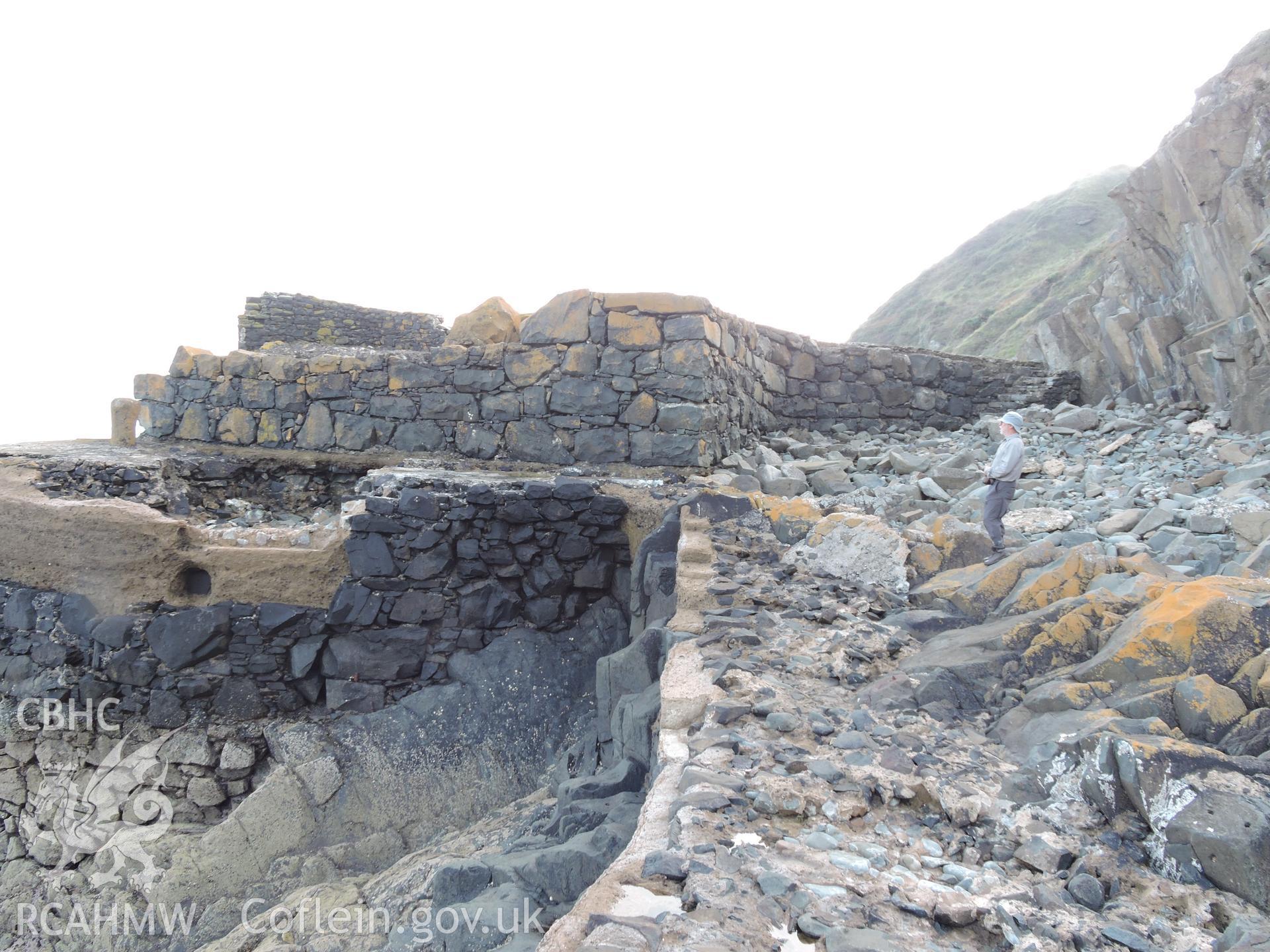 View of the wall at the quay, with human for scale. Part of a digital photographic survey of Porth y Pistyll, Aberdaron, produced in 2020 by Michael Statham.