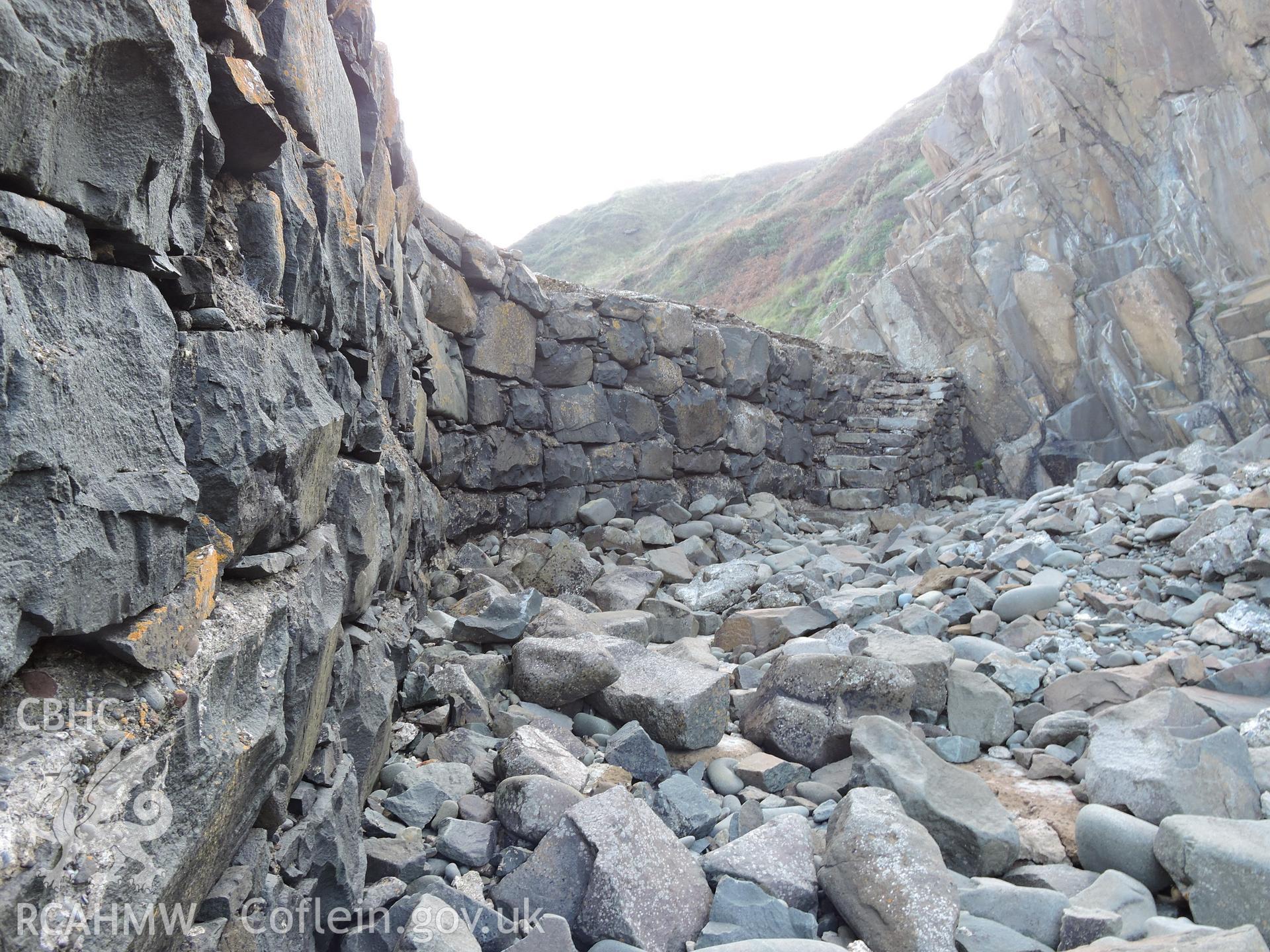 Deetailed view of quay wall, with stone steps built in at the far end. Part of a digital photographic survey of Porth y Pistyll, Aberdaron, produced in 2020 by Michael Statham.