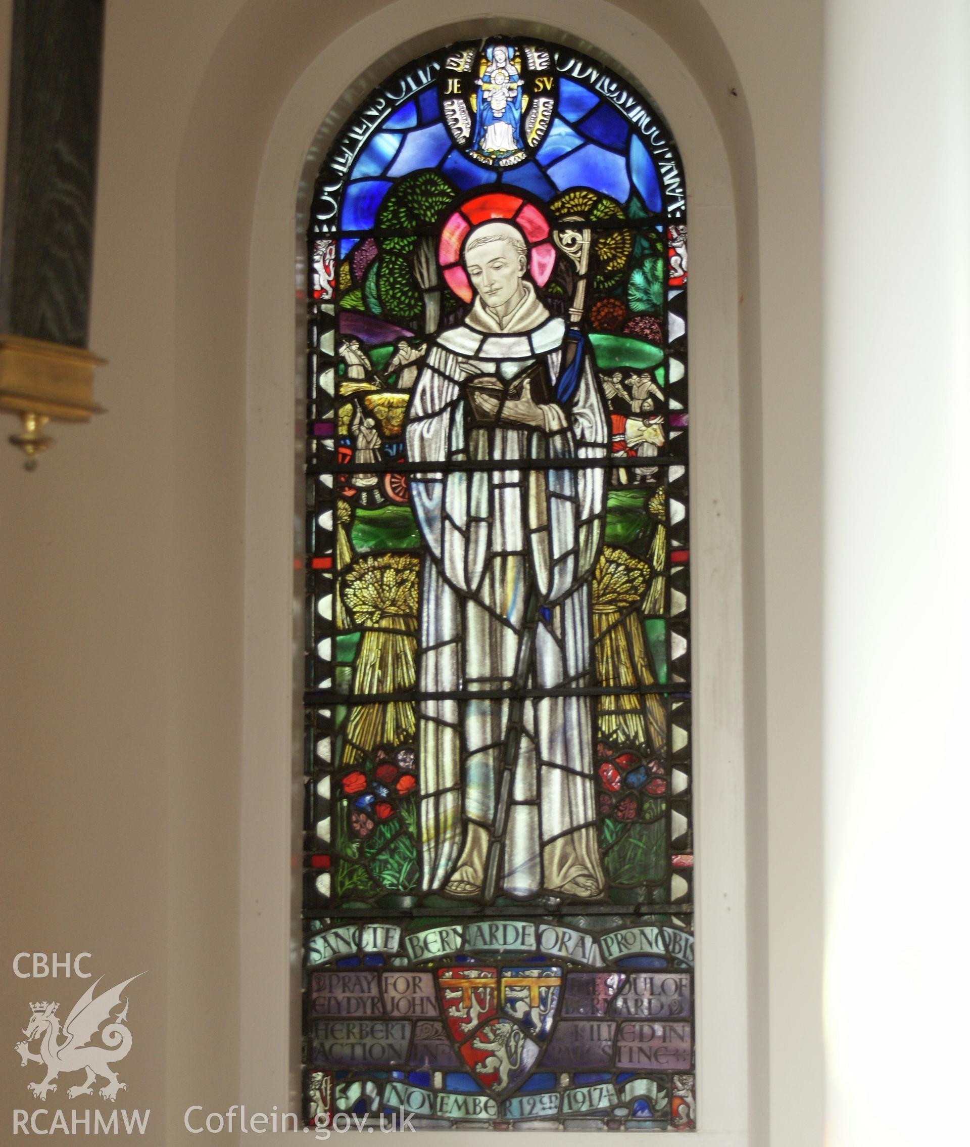 Digital colour photograph showing stained glass depicting St Bernard at St Mary and St Michael Catholic church, Llanarth.