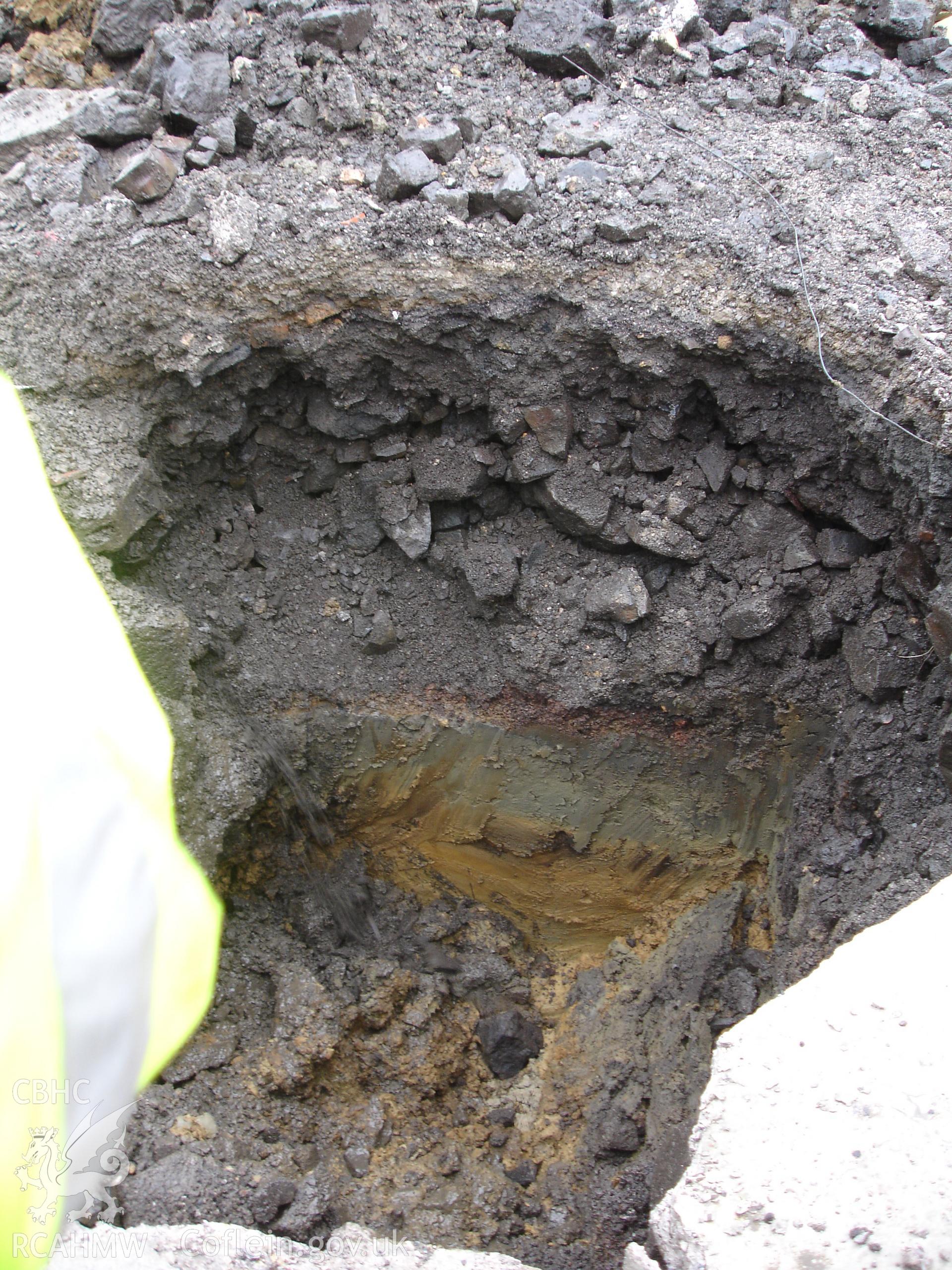Digital colour photograph of pit 2, showing context 006 overlaying the silty layers contexts 003 and 004. Taken from a watching brief of Cwm Yard, Gorseinon.