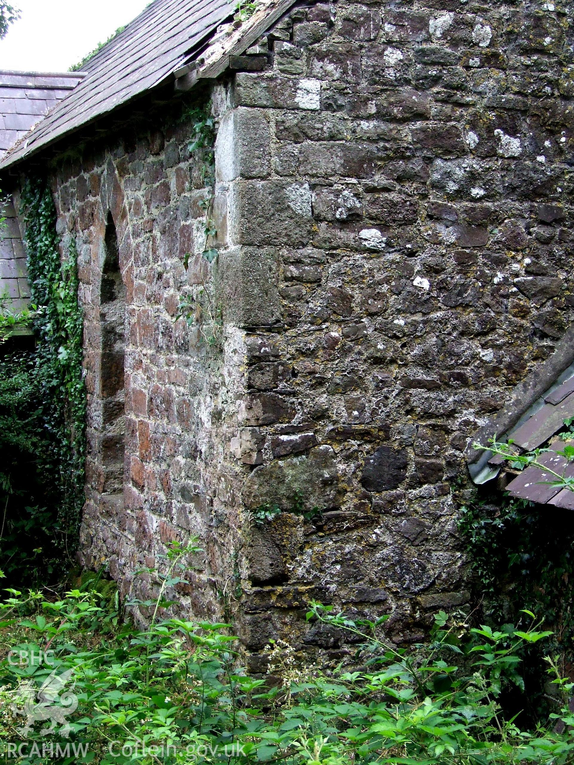 Digital colour photograph showing exterior - corner uncut coins, up to 6', Castell Dwyran church.