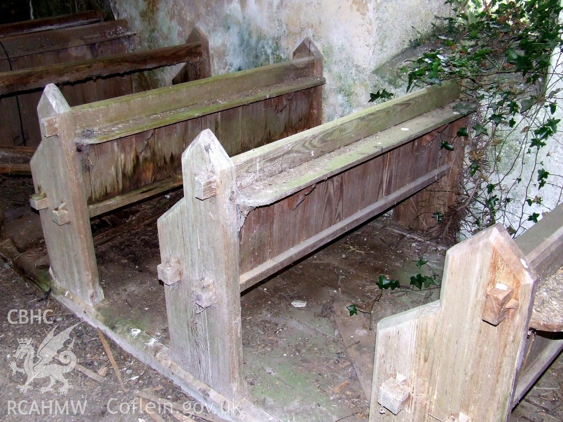 Digital colour photograph showing interior - pews at Castell Dwyran church.