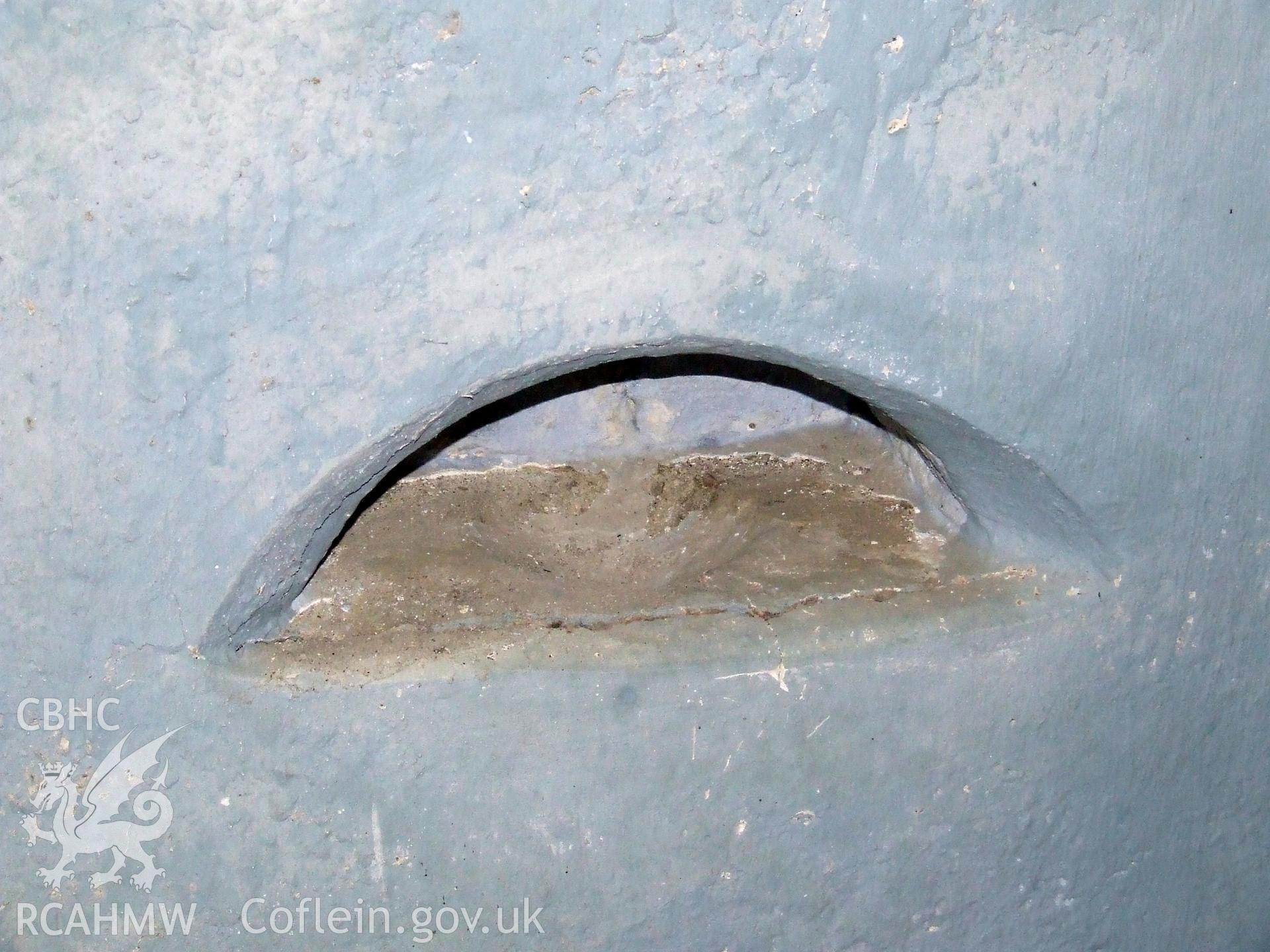 Digital colour photograph showing interior - stoup, Castell Dwyran church.
