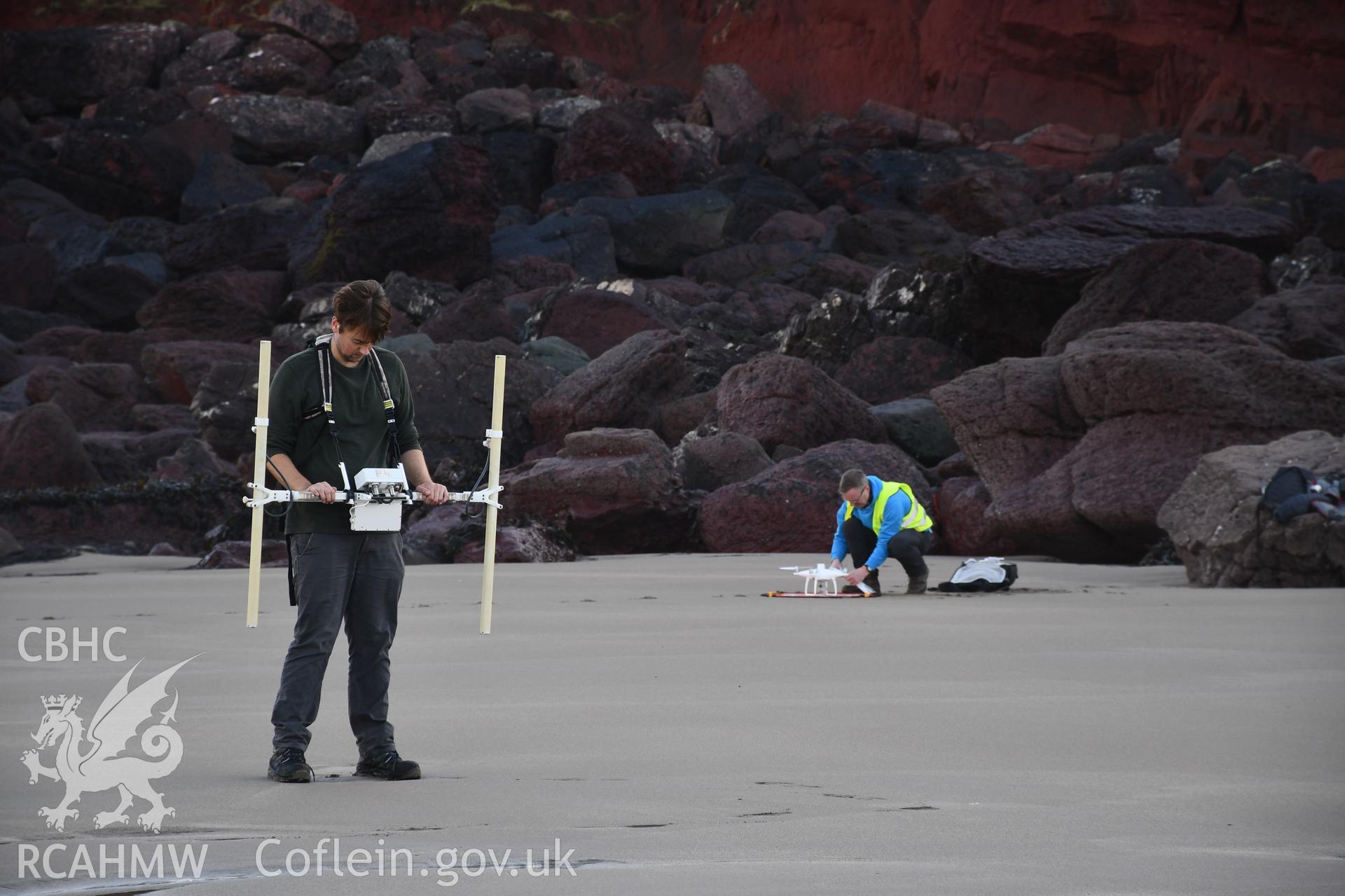 CHERISH team undertaking geophysical survey and drone survey. Camera facing E. Taken by Hannah Genders Boyd. Produced with EU funds through the Ireland Wales Co-operation Programme 2014-2023. All material made freely available through the Open Government