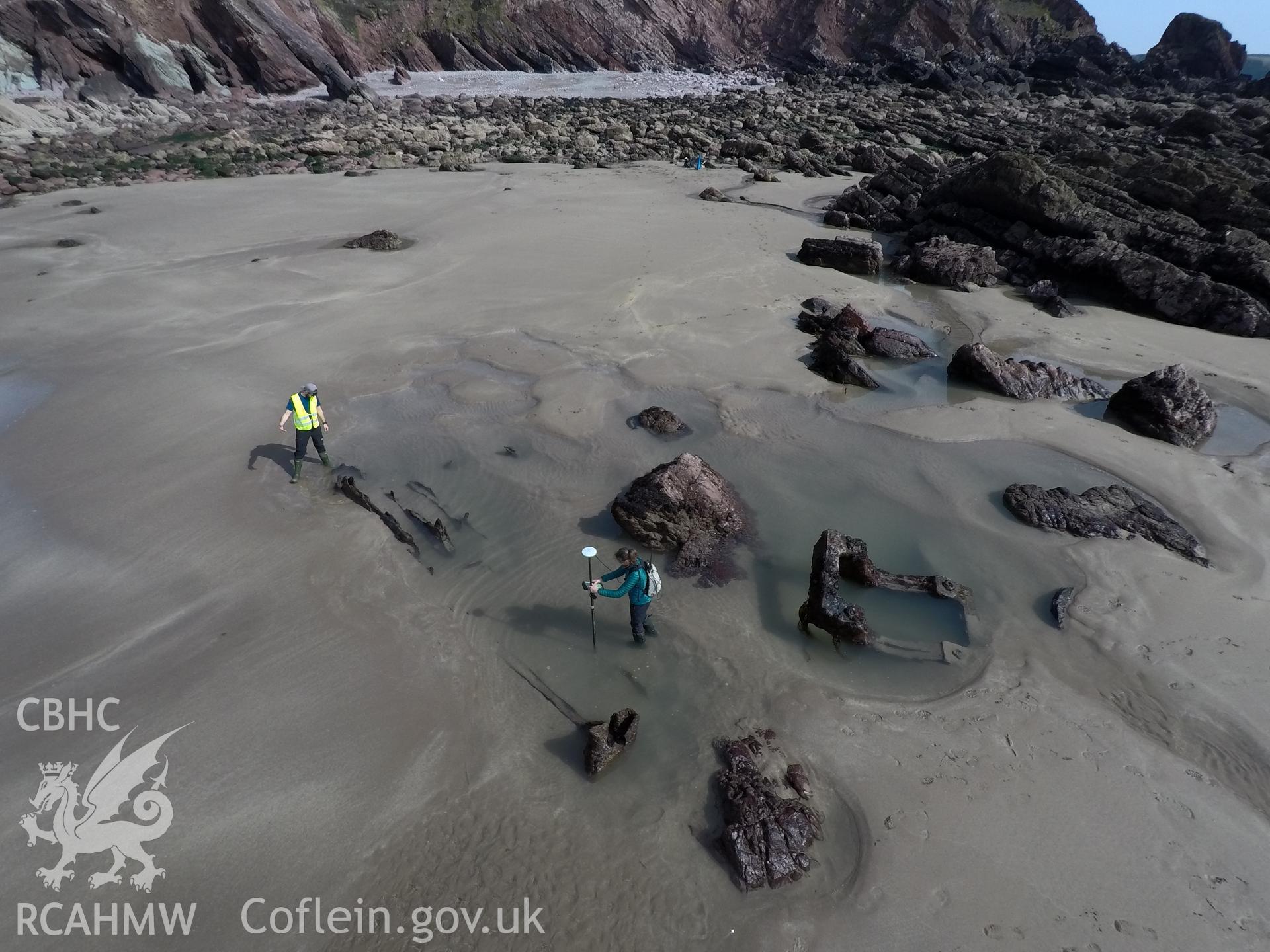Pole camera shot of CHERISH team surveying the Albion paddle steamer shipwreck, exposed on the beach at low tide Taken by Daniel Hunt. Produced with EU funds through the Ireland Wales Co-operation Programme 2014-2023. All material made freely available th
