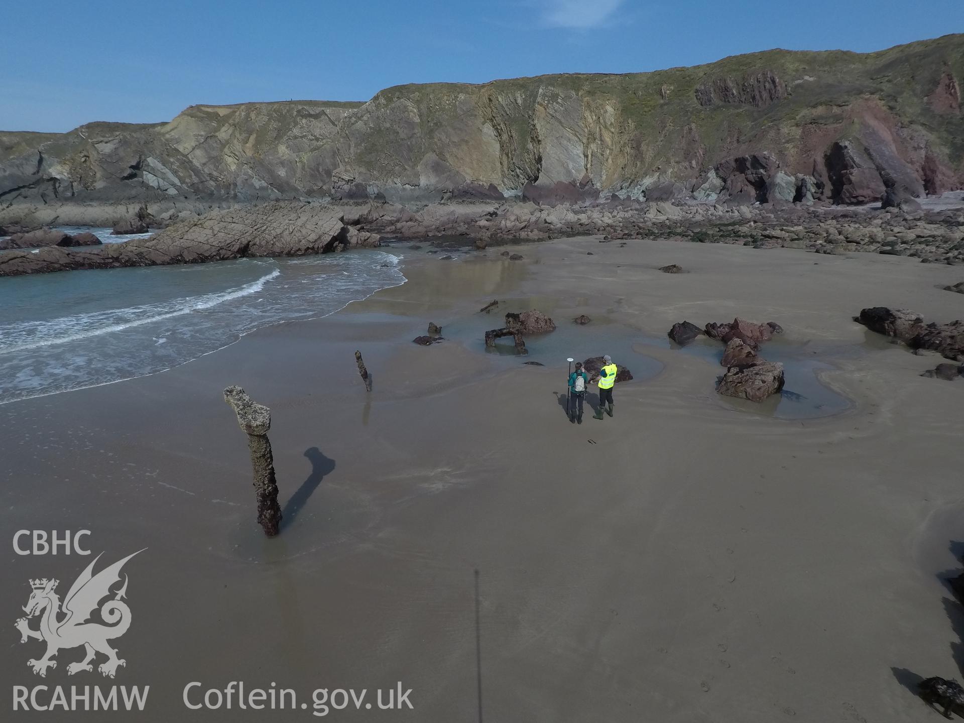 Pole camera shot of CHERISH team surveying the Albion paddle steamer shipwreck, exposed on the beach at low tide Taken by Daniel Hunt. Produced with EU funds through the Ireland Wales Co-operation Programme 2014-2023. All material made freely available th