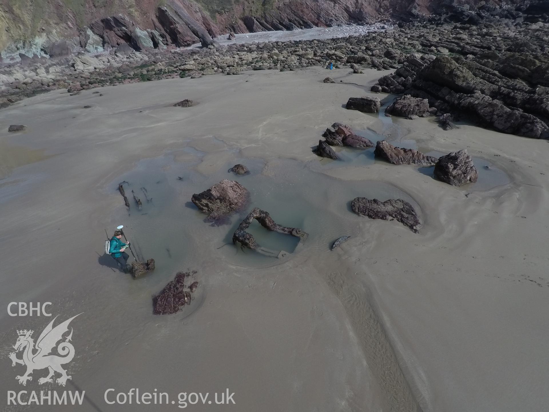 Pole camera shot of CHERISH team surveying the Albion paddle steamer shipwreck, exposed on the beach at low tide Taken by Daniel Hunt. Produced with EU funds through the Ireland Wales Co-operation Programme 2014-2023. All material made freely available th