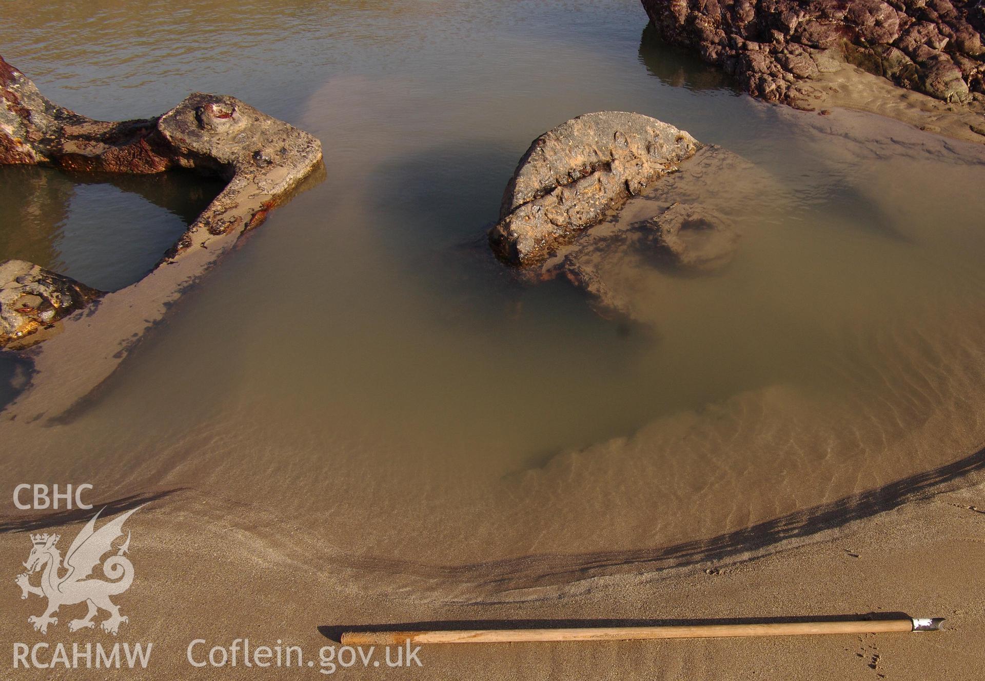Parts of the wreck partially exposed on the beach, partially submerged. Taken by Hannah Genders Boyd. Produced with EU funds through the Ireland Wales Co-operation Programme 2014-2023. All material made freely available through the Open Government Licence