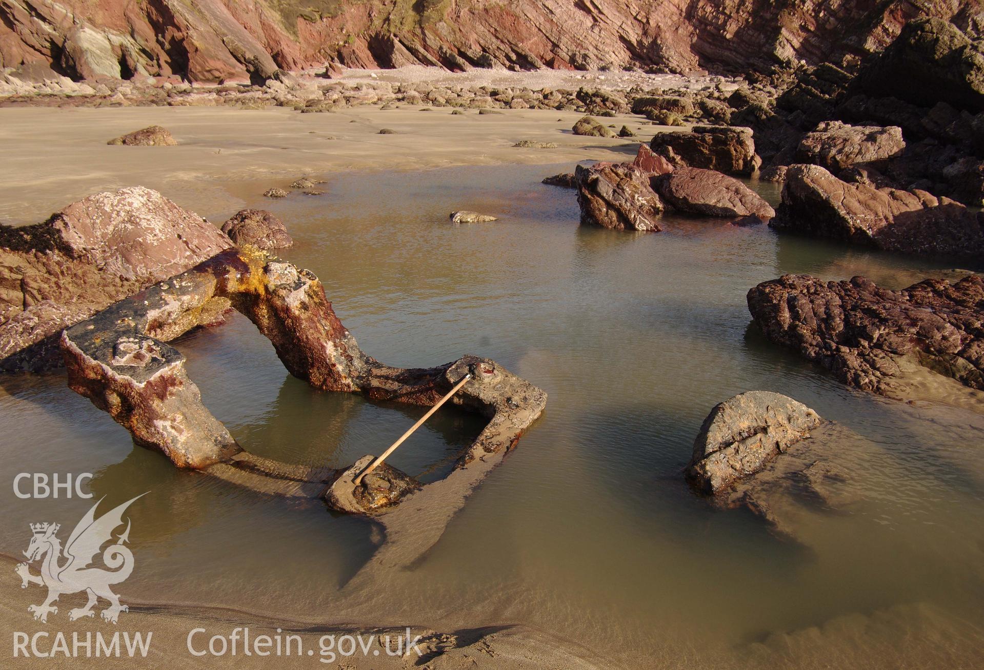 Parts of the wreck partially exposed on the beach, partially submerged. Taken by Hannah Genders Boyd. Produced with EU funds through the Ireland Wales Co-operation Programme 2014-2023. All material made freely available through the Open Government Licence