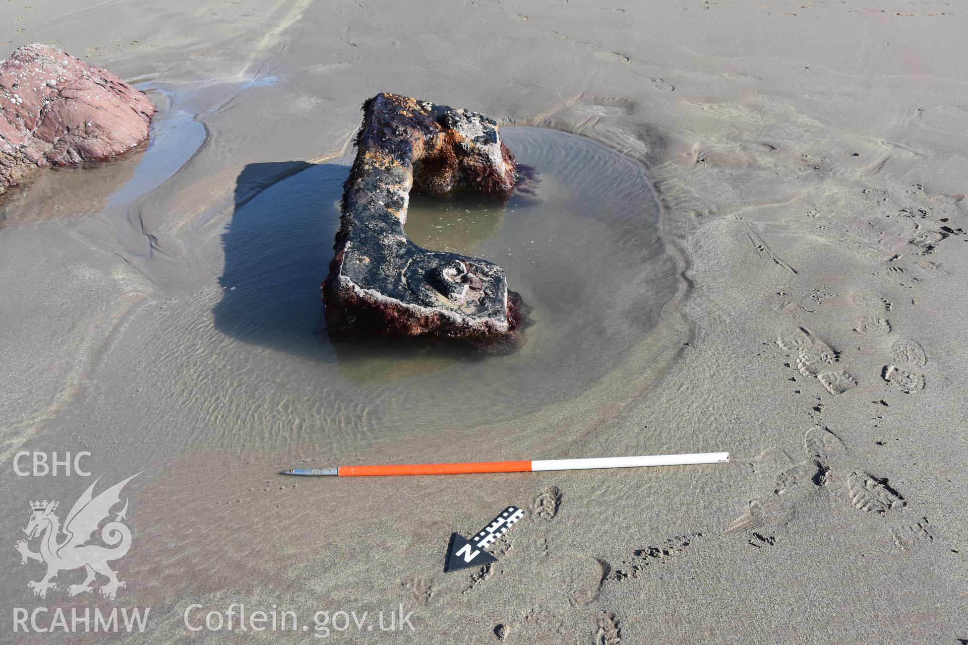 Element of the wreck exposed on the sand with 1m scale Taken by Daniel Hunt. Produced with EU funds through the Ireland Wales Co-operation Programme 2014-2023. All material made freely available through the Open Government Licence.
