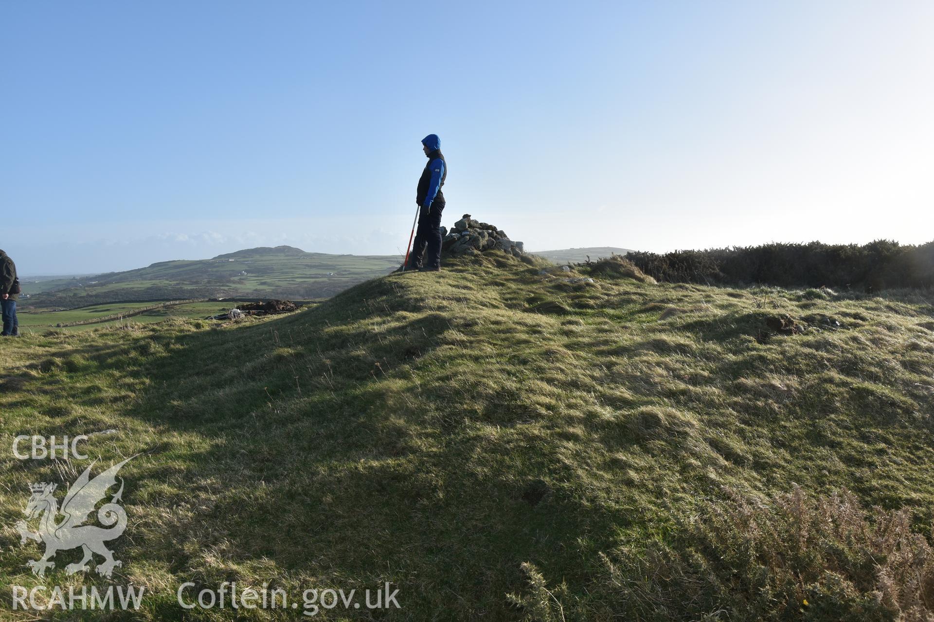 Pen Bryn yr Eglwys with figure and 2m scale. Taken by Lou Barker. Produced with EU funds through the Ireland Wales Co-operation Programme 2014-2023. All material made freely available through the Open Government Licence.