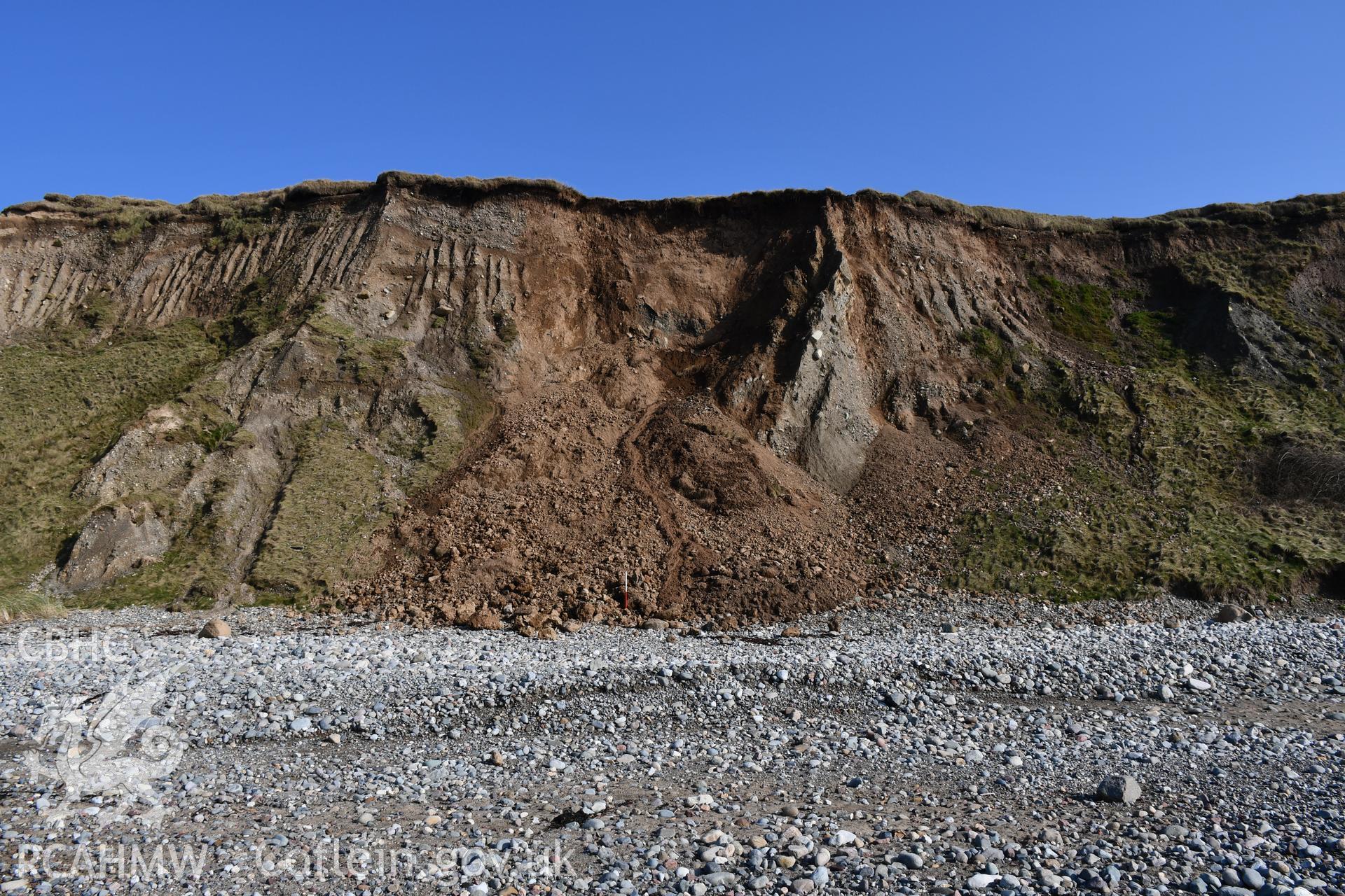 Wide shot showing newly exposed area of the cliff face following a collapse of sediment. Taken by Toby Driver. Produced with EU funds through the Ireland Wales Co-operation Programme 2014-2023. All material made freely available through the Open Governmen
