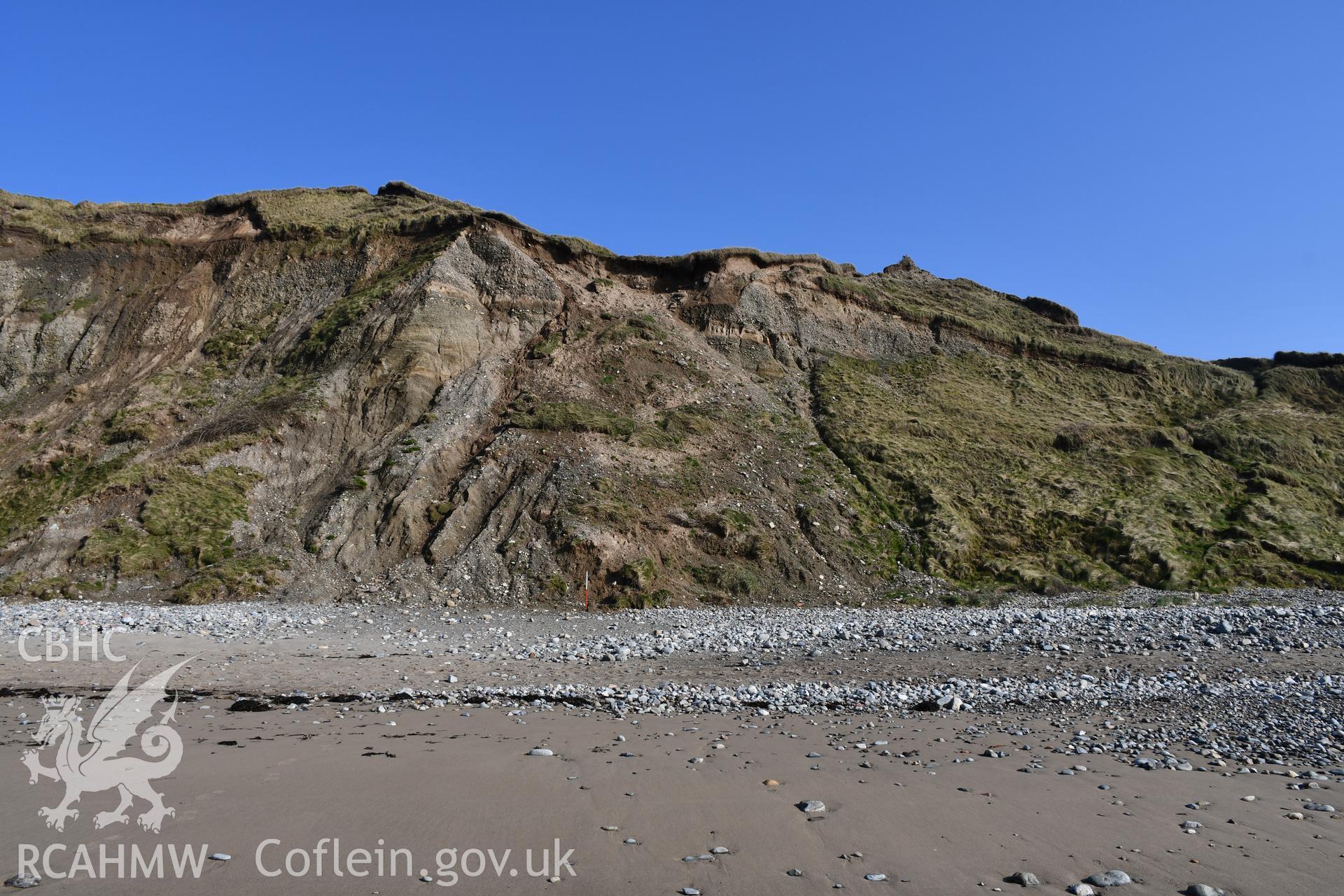 General shot of eroding cliff face with 2m scale. Taken by Toby Driver. Produced with EU funds through the Ireland Wales Co-operation Programme 2014-2023. All material made freely available through the Open Government Licence.