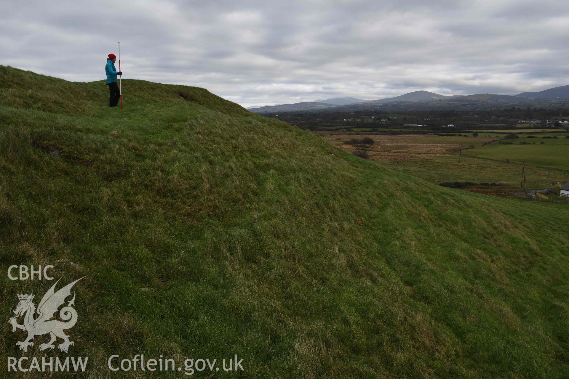 Southern ramparts with figure and 2m scale. Taken by Hannah Genders Boyd. Produced with EU funds through the Ireland Wales Co-operation Programme 2014-2023. All material made freely available through the Open Government Licence.