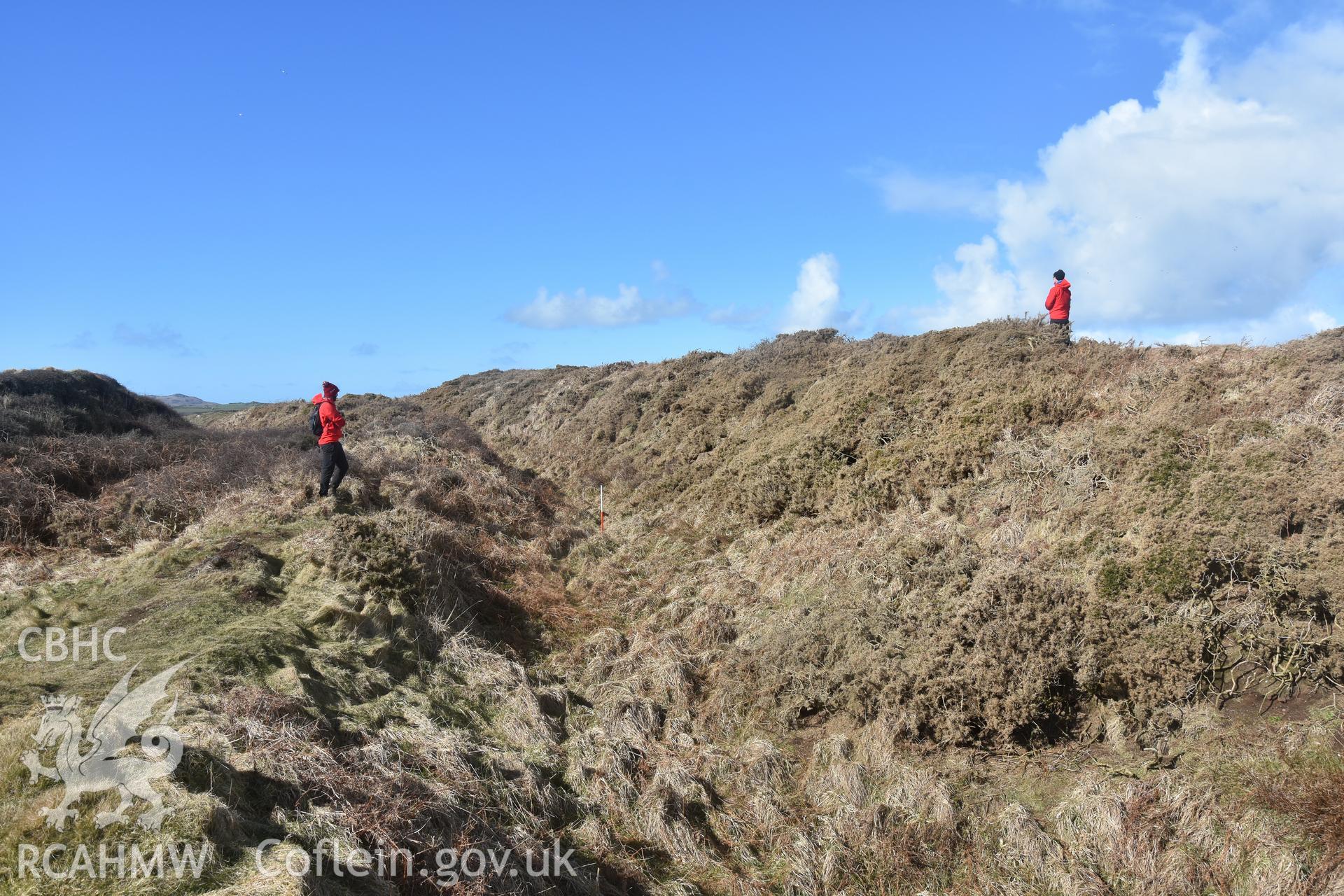 Ramparts with figure and 1m scale Taken by Toby Driver. Produced with EU funds through the Ireland Wales Co-operation Programme 2014-2023. All material made freely available through the Open Government Licence.