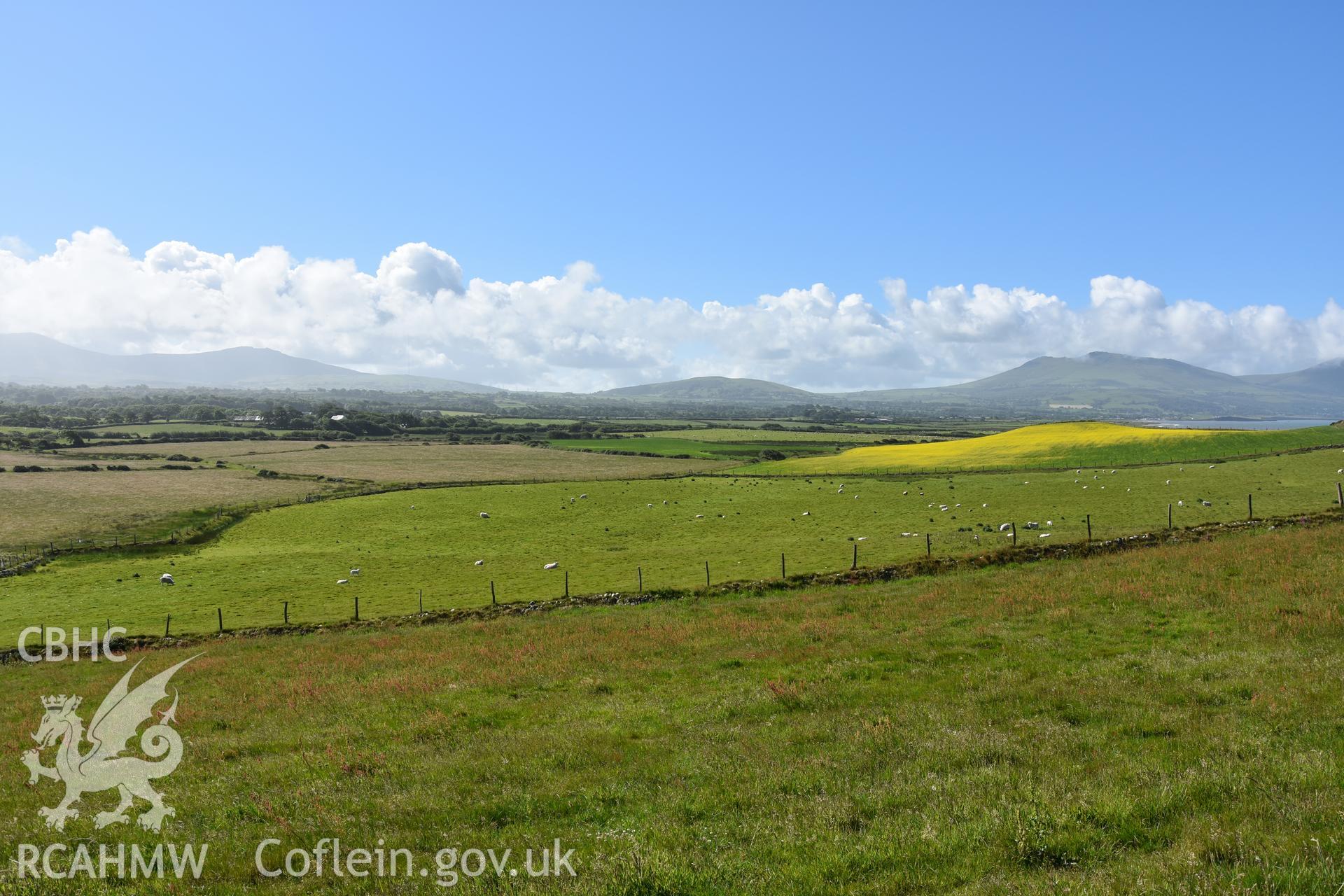 Looking into the southern field from the hillfort. Taken by Daniel Hunt. Produced with EU funds through the Ireland Wales Co-operation Programme 2014-2023. All material made freely available through the Open Government Licence.