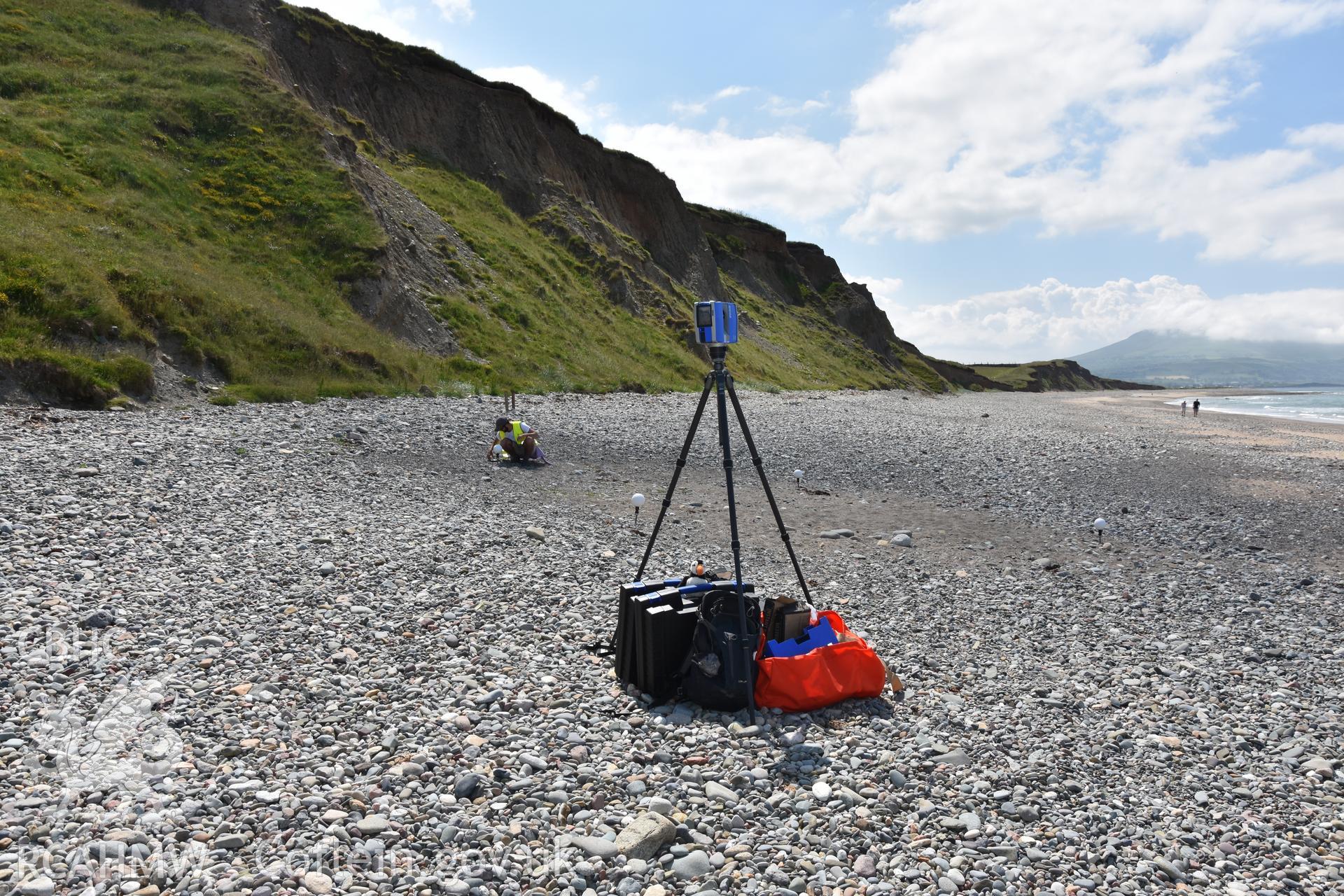 Laser scanner on the beach with member of the CHERISH team. Taken by Daniel Hunt. Produced with EU funds through the Ireland Wales Co-operation Programme 2014-2023. All material made freely available through the Open Government Licence.