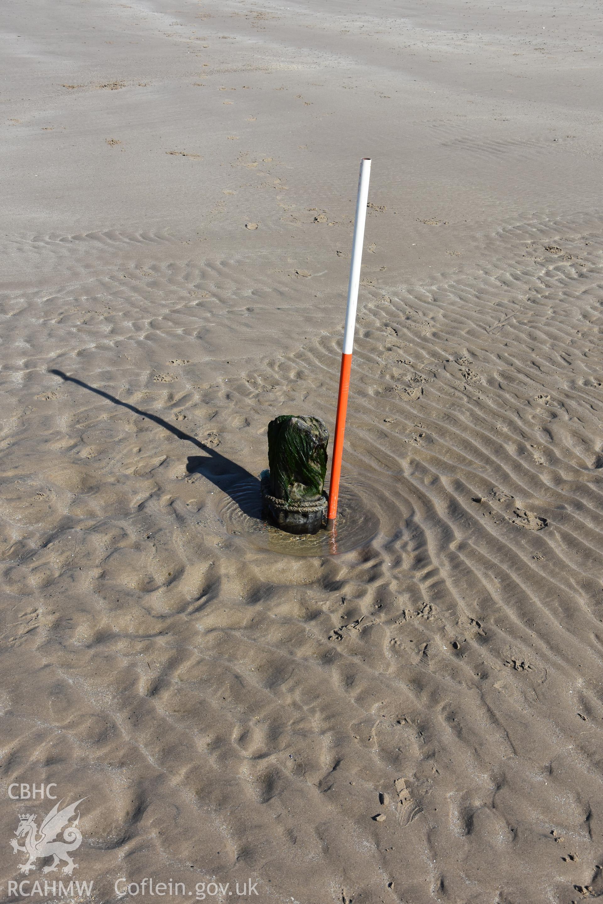 Part of a wreck at Morfa Dinlle with 2m vertical scale. Photograph taken by Toby Driver in March 2019 as part of repeat monitoring and survey by the CHERISH project. © Crown: CHERISH PROJECT 2019. Produced with EU funds through the Ireland Wales Co-operation Programme 2014-2023. All material made freely available through the Open Government Licence.