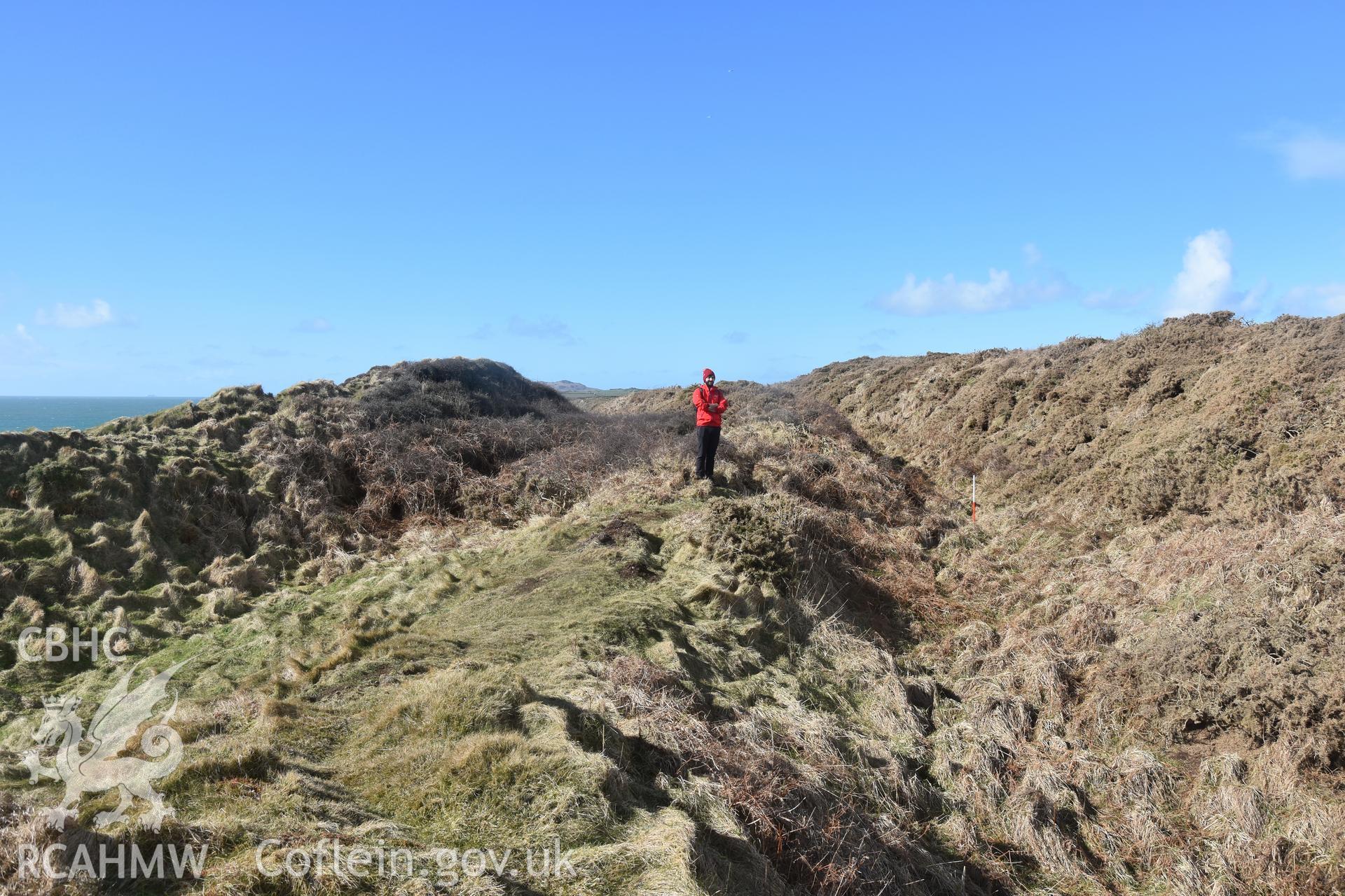 Ramparts with figures for scale Taken by Toby Driver. Produced with EU funds through the Ireland Wales Co-operation Programme 2014-2023. All material made freely available through the Open Government Licence.