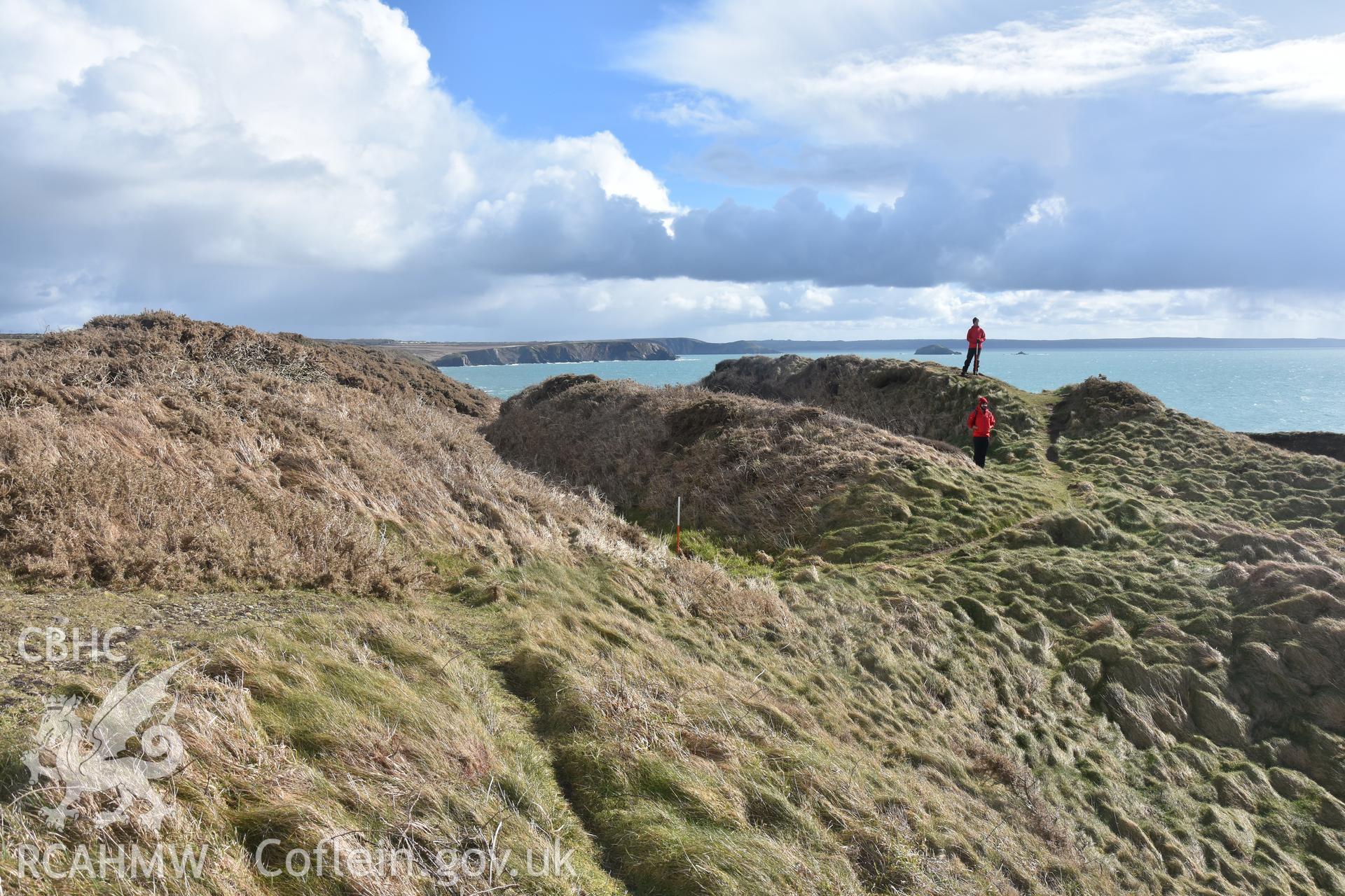 Ramparts with figures for scale Taken by Toby Driver. Produced with EU funds through the Ireland Wales Co-operation Programme 2014-2023. All material made freely available through the Open Government Licence.
