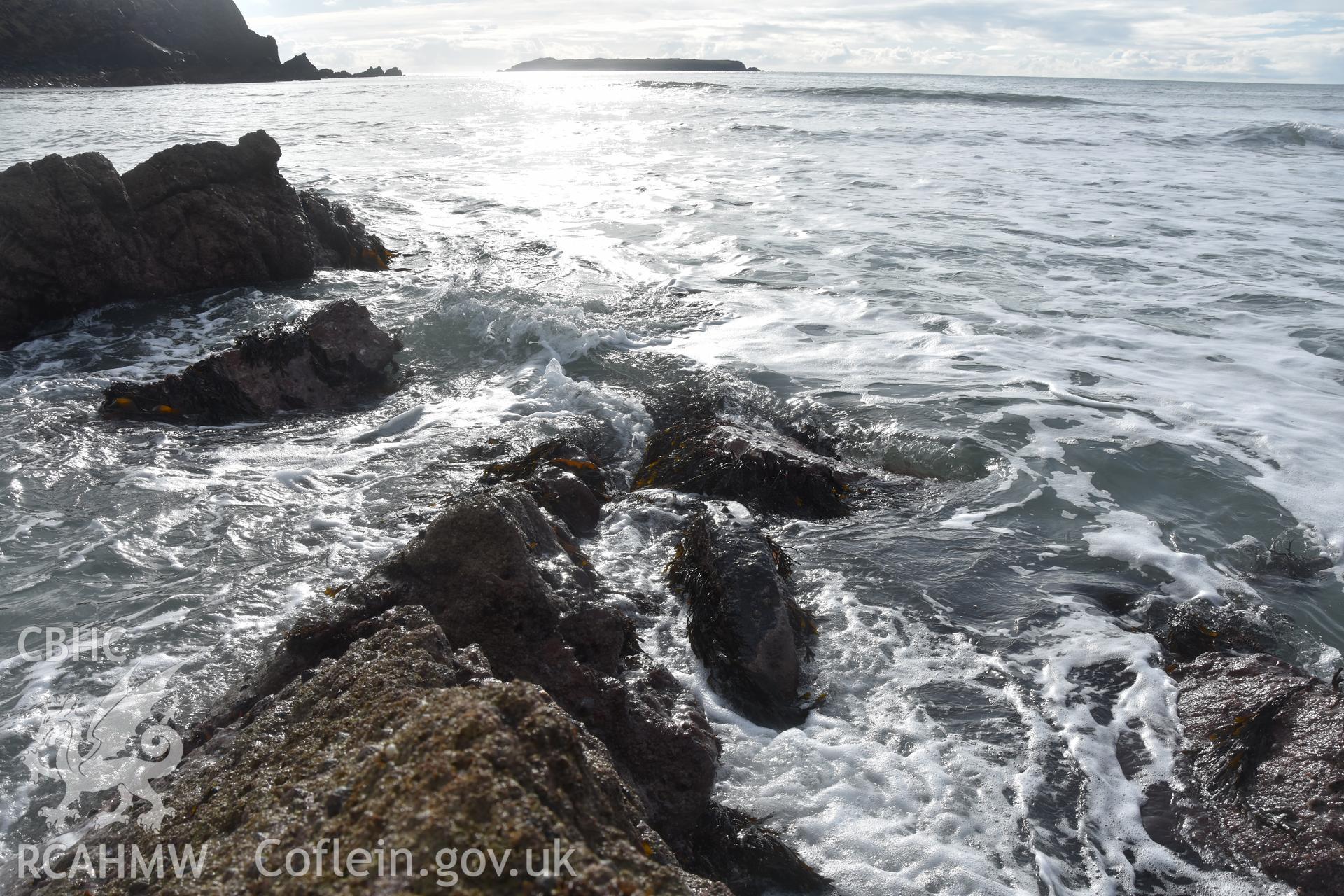 Sea coming in over rocks and wreck Taken by Daniel Hunt. Produced with EU funds through the Ireland Wales Co-operation Programme 2014-2023. All material made freely available through the Open Government Licence.
