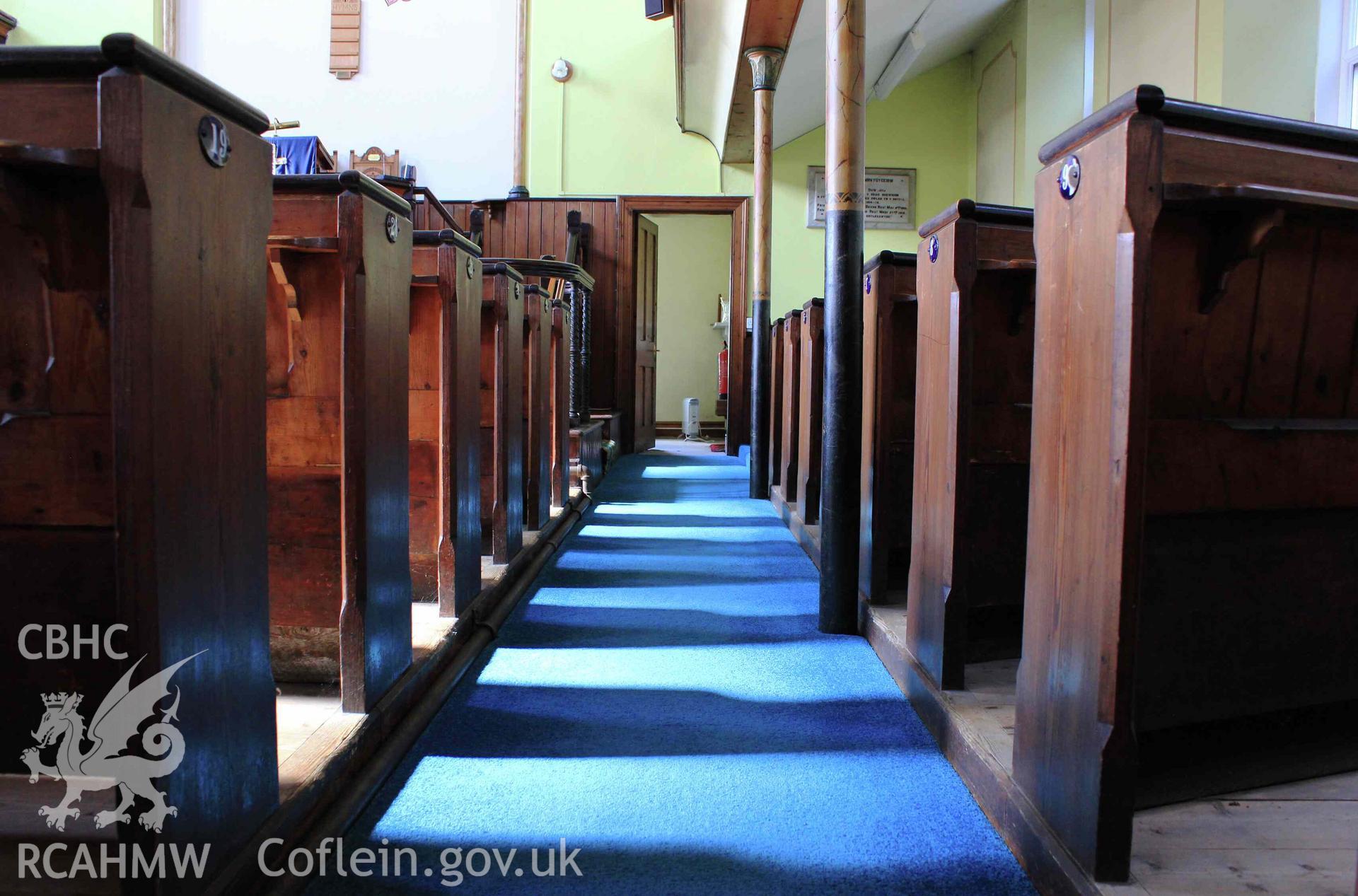 North aisle low angle towards pulpit. Shadows of benches.