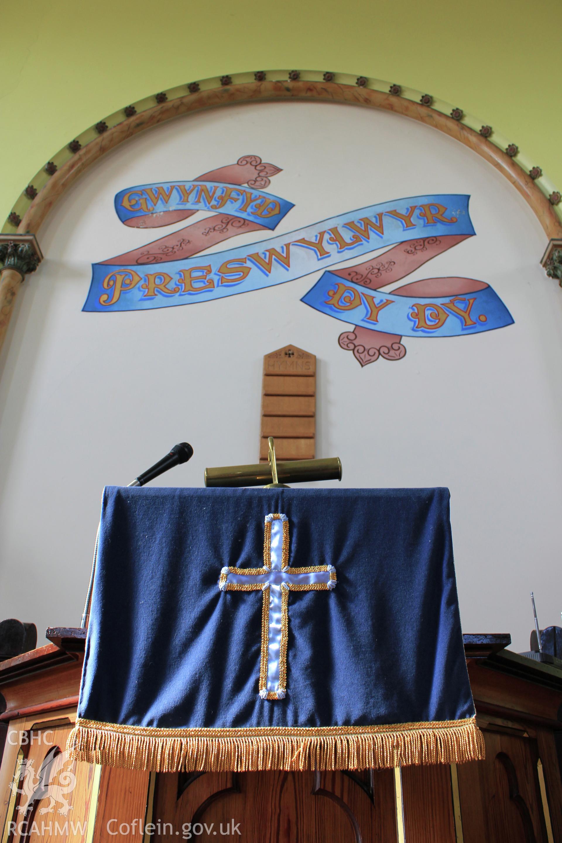 Parament and mural above pulpit.