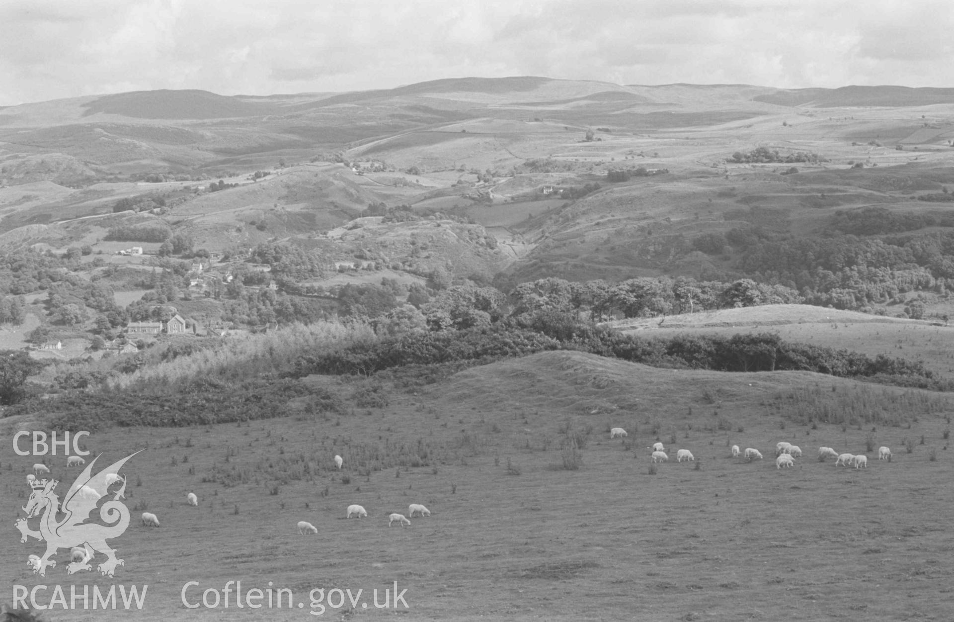 Digital copy of a black and white negative showing Pontrhydygroes and Trawsallt from the 1007ft summit above Maen Arthur. Photographed by Arthur Chater on 17 August 1968. Looking east south east from Grid Reference SN 728 726.