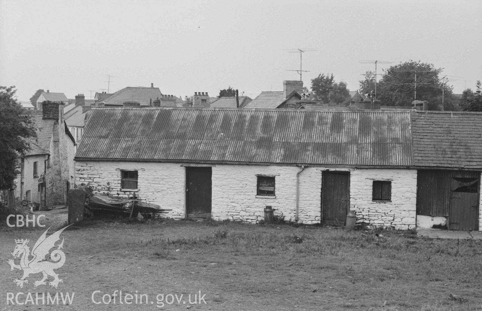 Digital copy of a black and white negative showing farmyard buildings behind the Talbot Hotel. Photographed by Arthur Chater on 29 August 1968. Looking west from Grid Reference SN 681 597.
