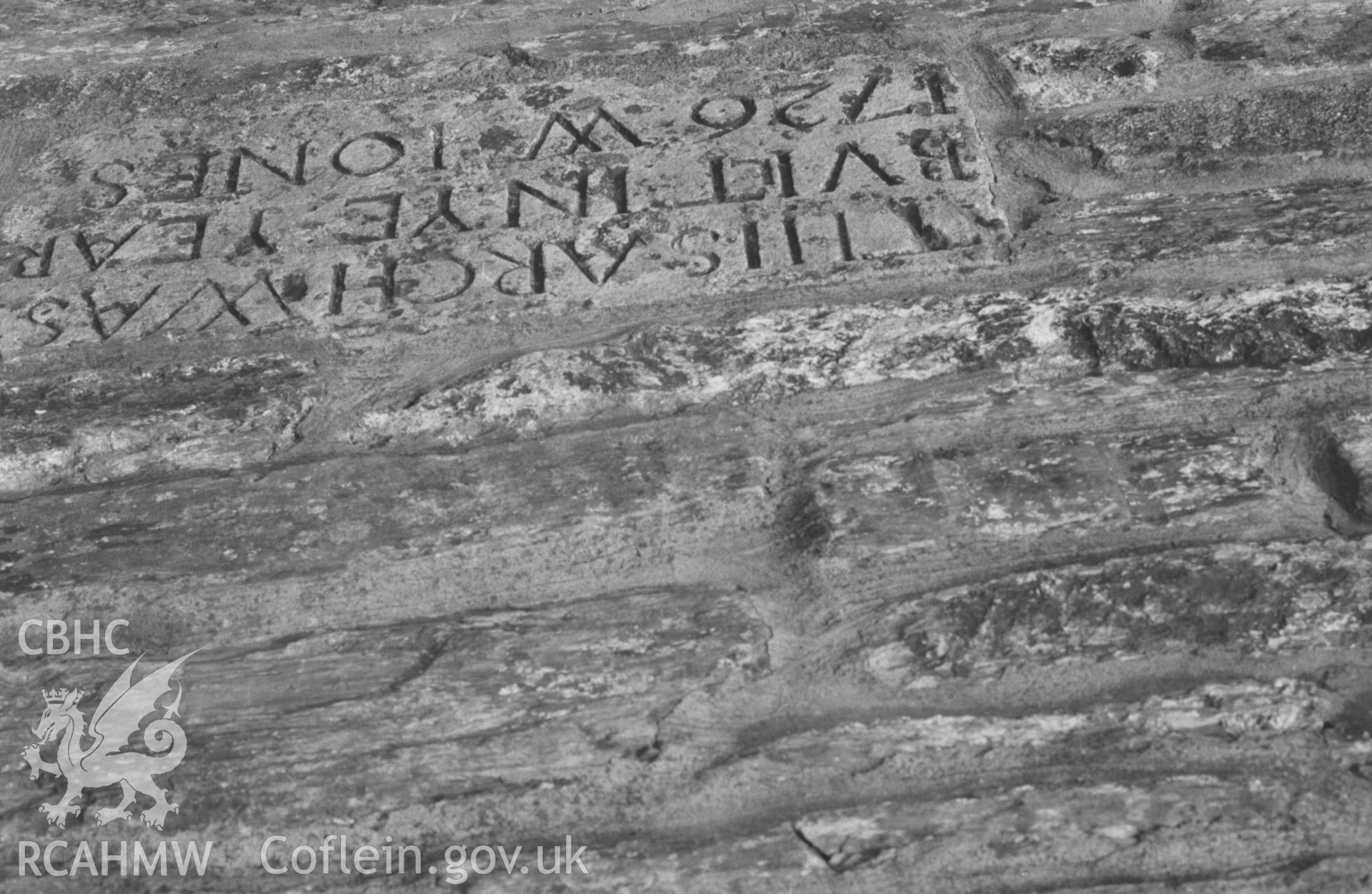 Digital copy of a black and white negative showing inscription on stone above cut-water on east side of Cardigan Bridge. Photographed by Arthur Chater on 30 August 1968. Looking west from Grid Reference SN 1778 4581.