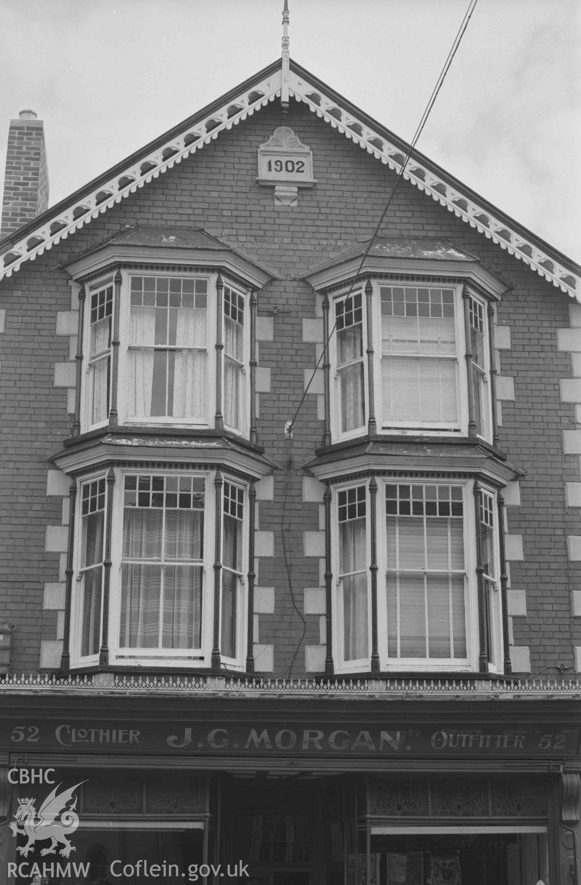 Digital copy of a black and white negative showing top stories of J. G. Morgan, Outfitters, 52 Pendre, at the corner of William Street in Cardigan. Photographed by Arthur Chater on 30 August 1968. Looking east south east from Grid Reference SN 1781 4622.